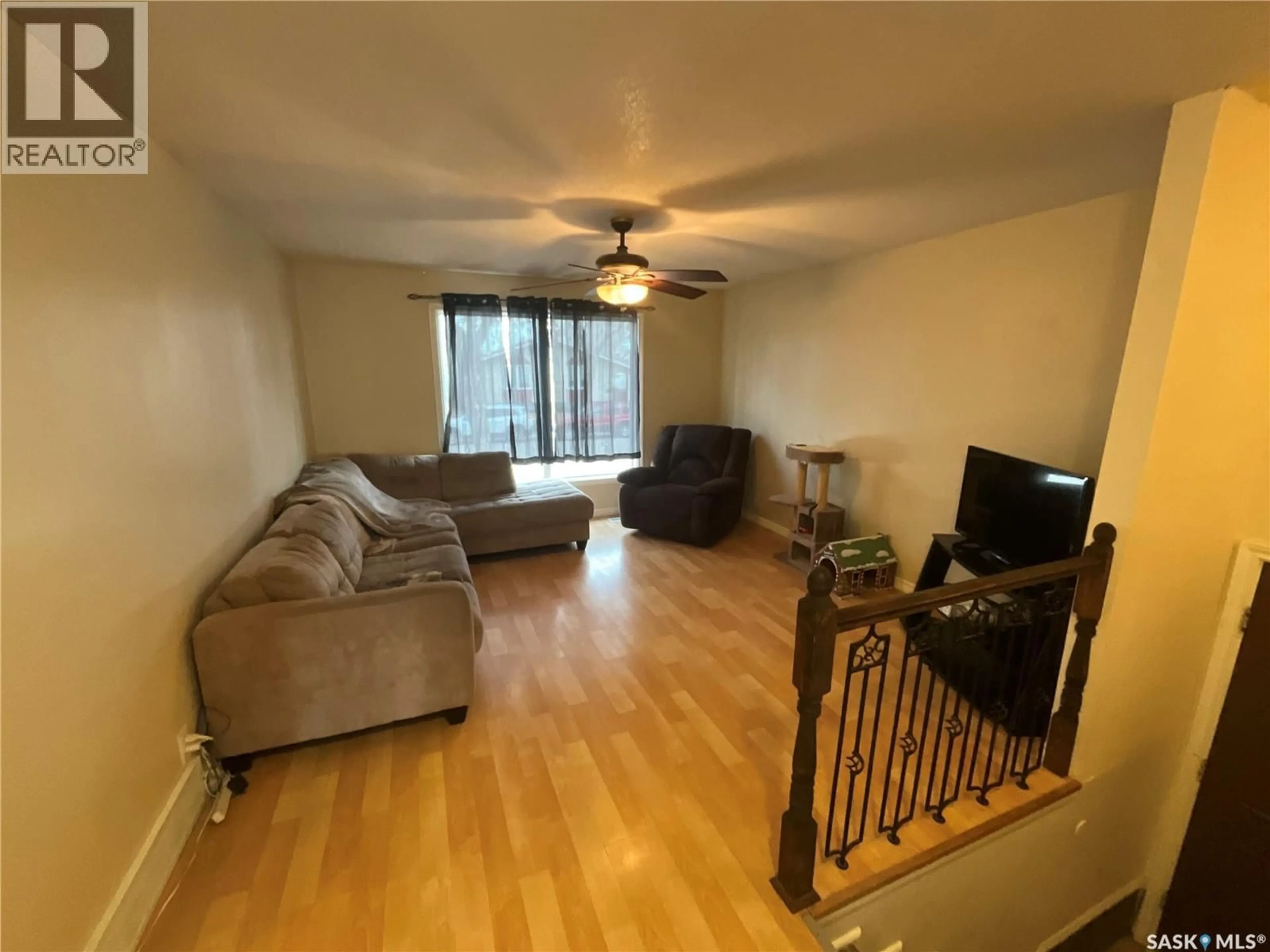 Living room with furniture, wood/laminate floor for 62 ANDREWS CRESCENT, Regina Saskatchewan S4R7X7