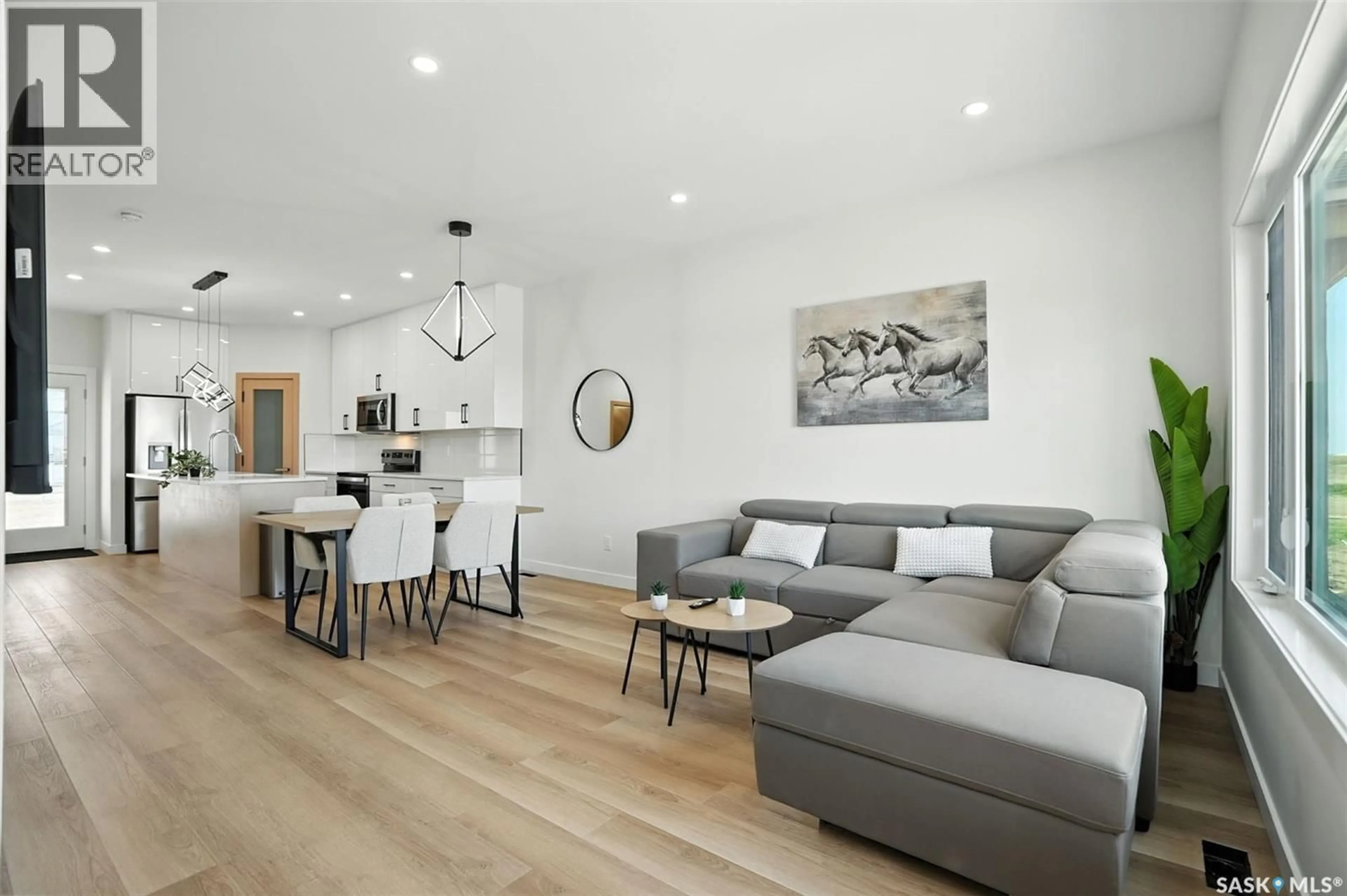 Living room with furniture, wood/laminate floor for 1509 - 171 RICHARDSON ROAD, Saskatoon Saskatchewan S7L4E1