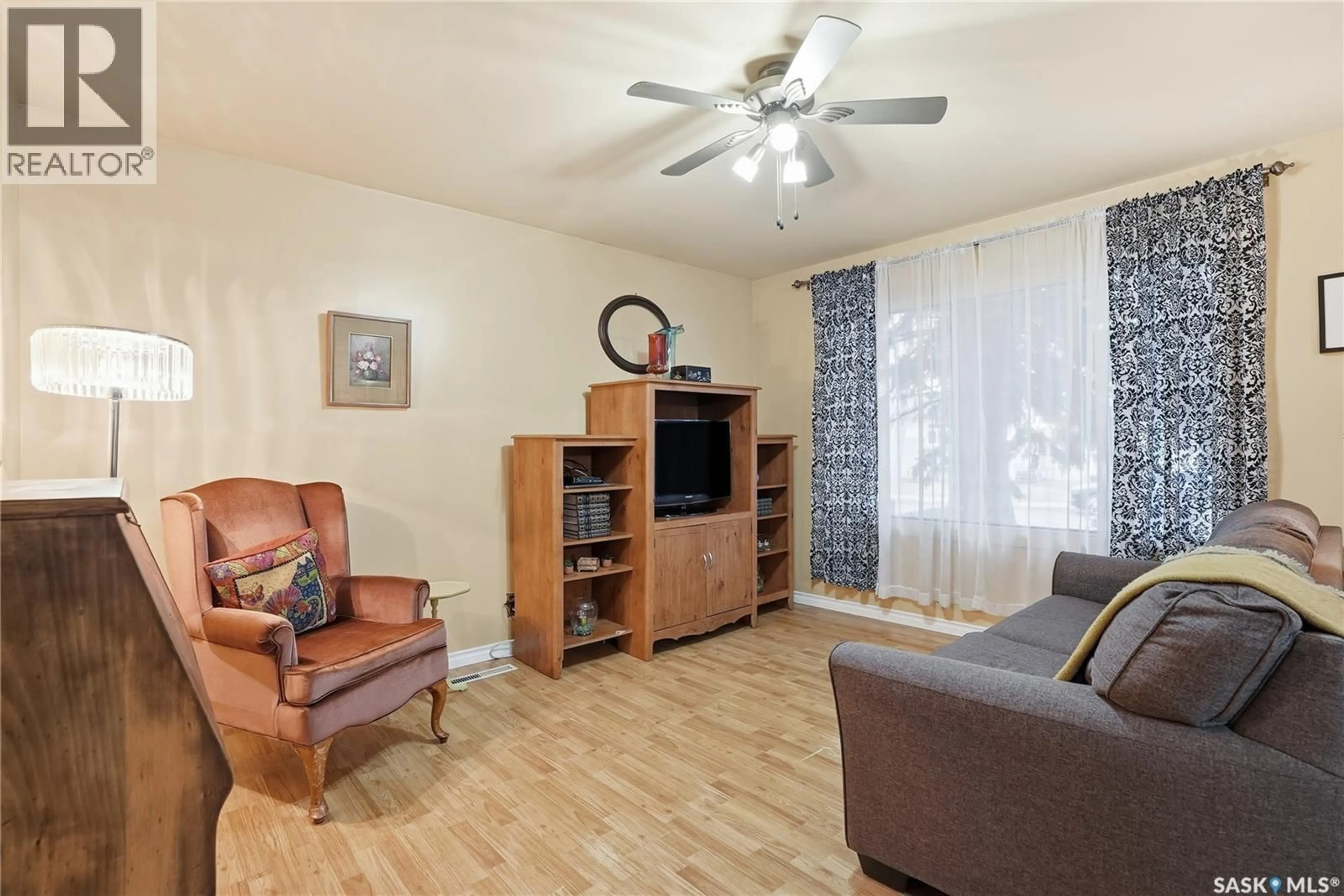 Living room with furniture, wood/laminate floor for 2120 ST ANDREWS AVENUE, Saskatoon Saskatchewan S7M0M1