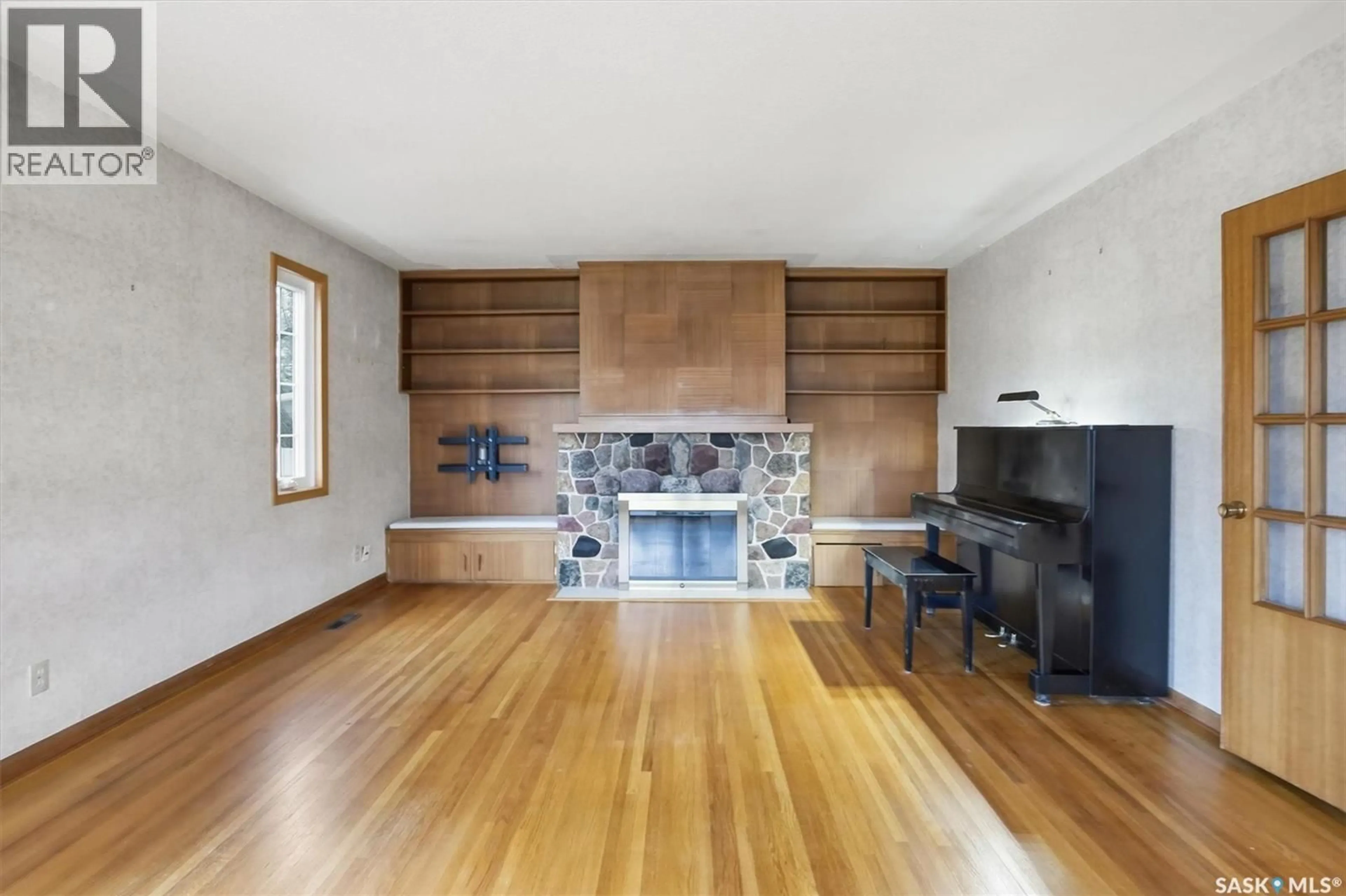 Living room with furniture, wood/laminate floor for 501 BATE CRESCENT, Saskatoon Saskatchewan S7H3A6