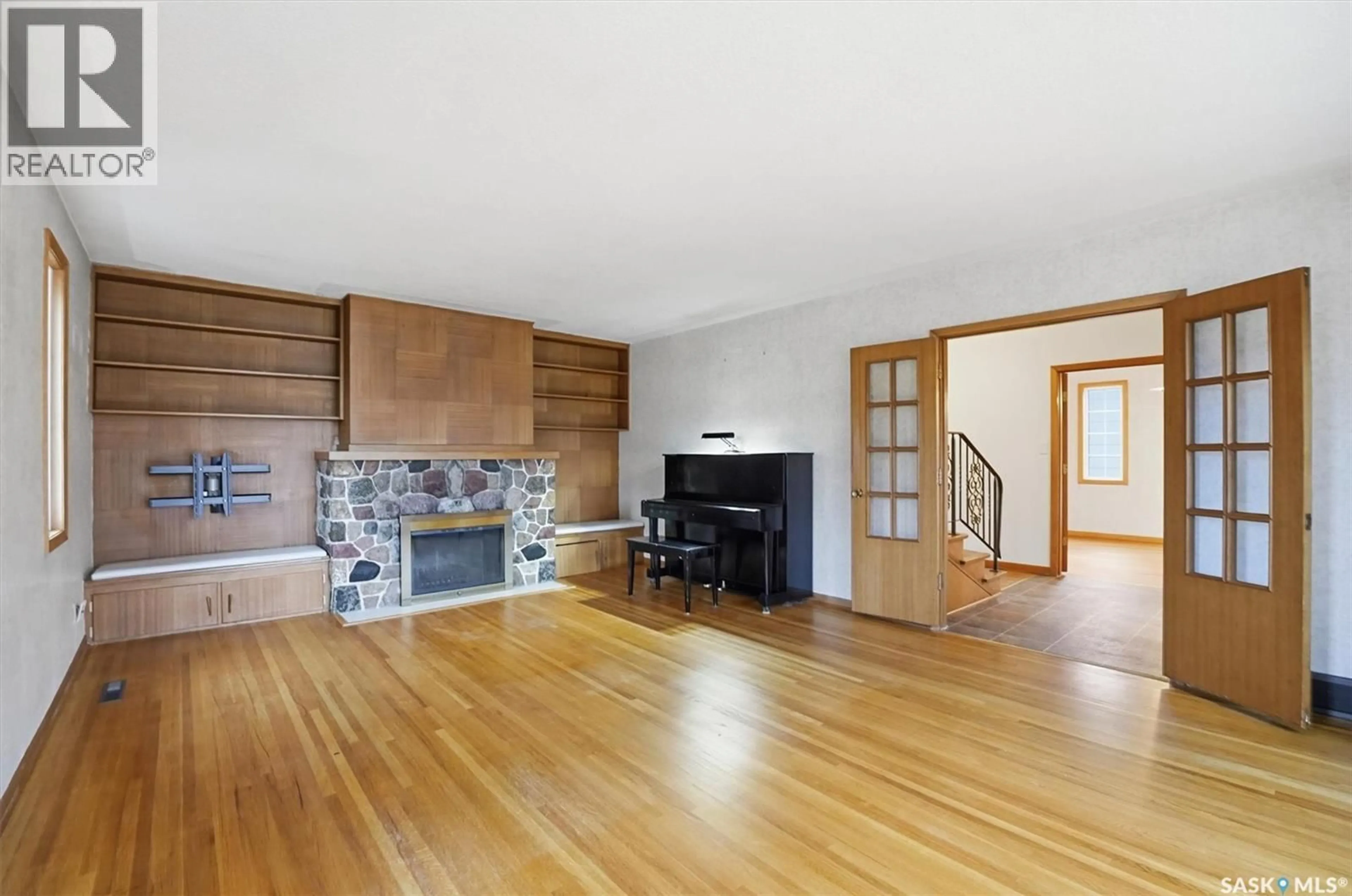 Living room with furniture, wood/laminate floor for 501 BATE CRESCENT, Saskatoon Saskatchewan S7H3A6