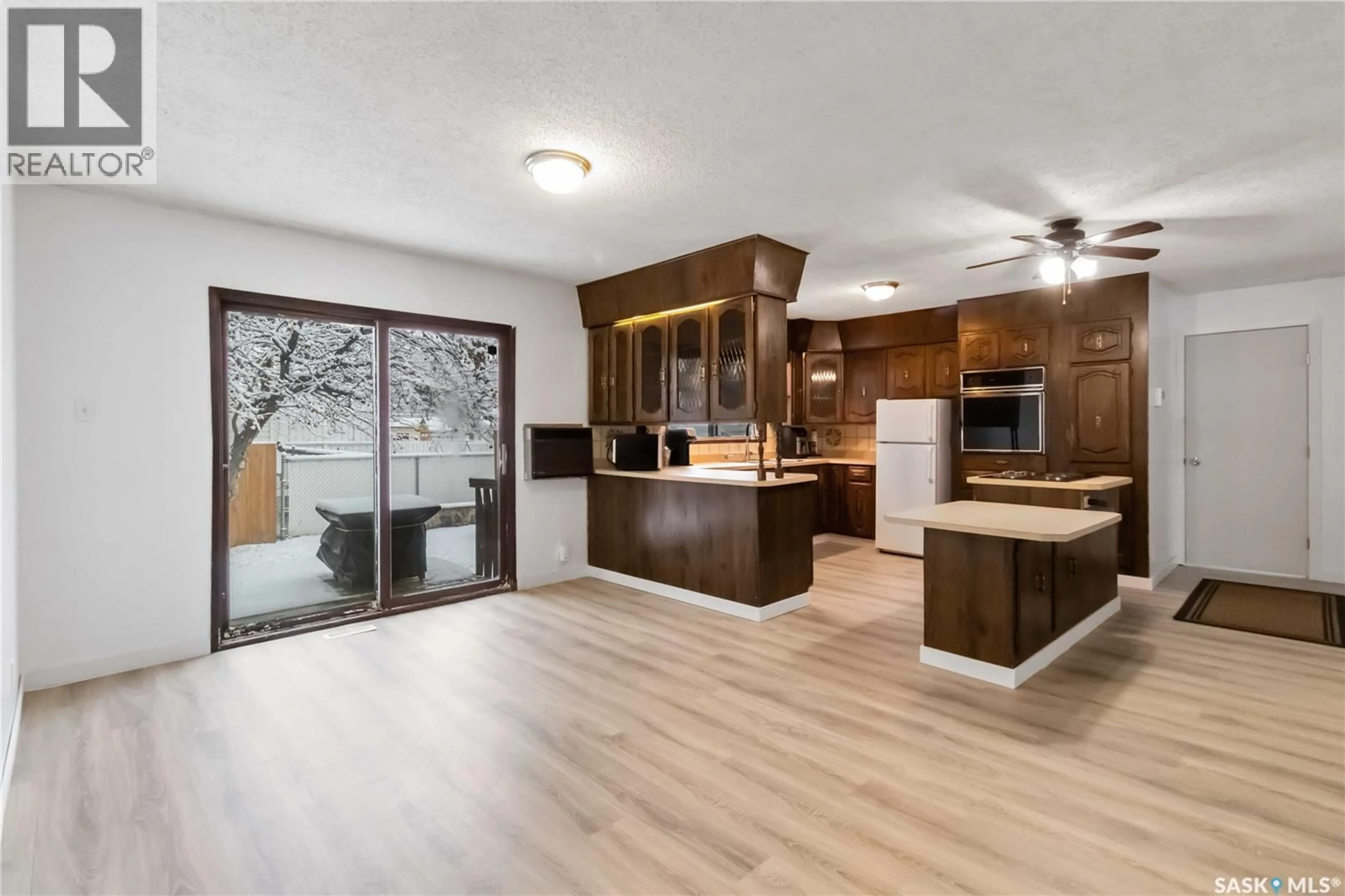Open concept kitchen, wood/laminate floor for 802 V AVENUE, Saskatoon Saskatchewan S7L3G1