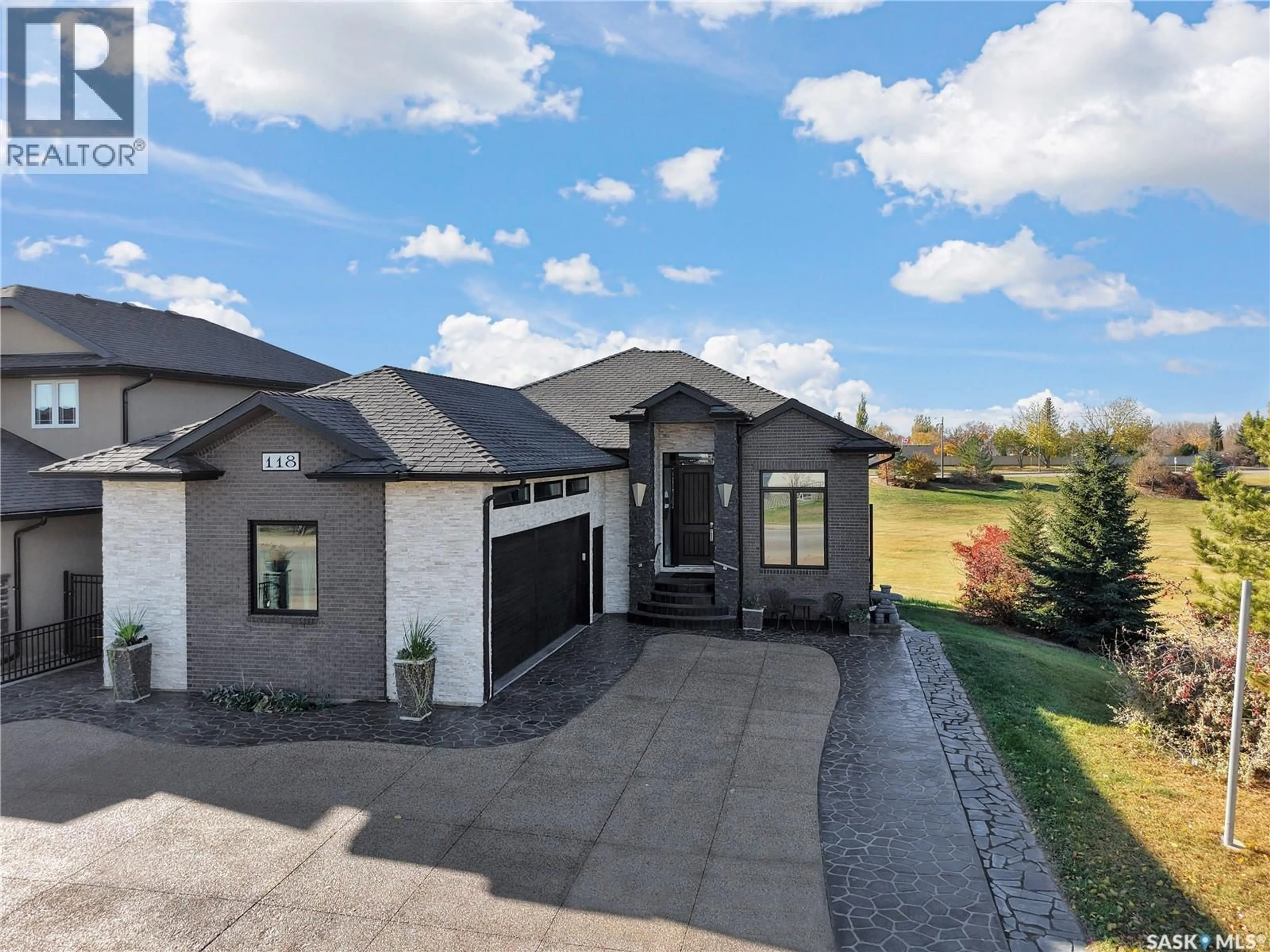Home with brick exterior material, street for 118 MUZYKA ROAD, Saskatoon Saskatchewan S7W0G9