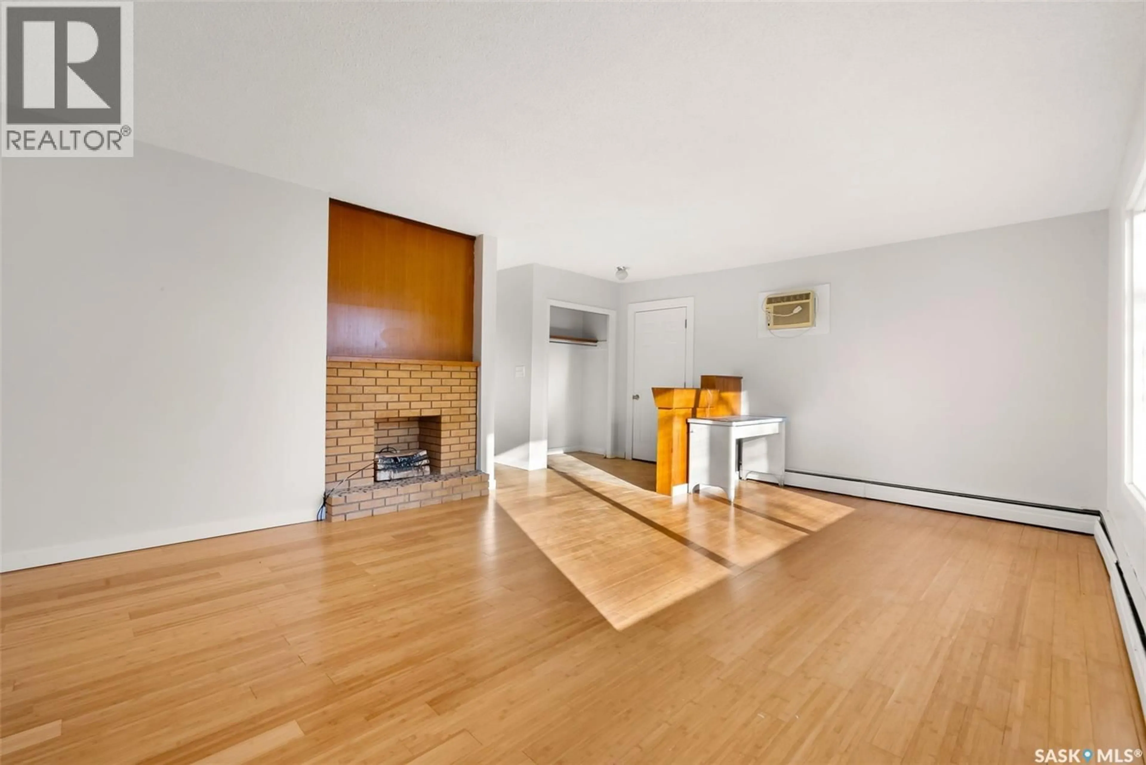 Living room with furniture, wood/laminate floor for 416 SOURIS AVENUE, Wilcox Saskatchewan S0G5E0