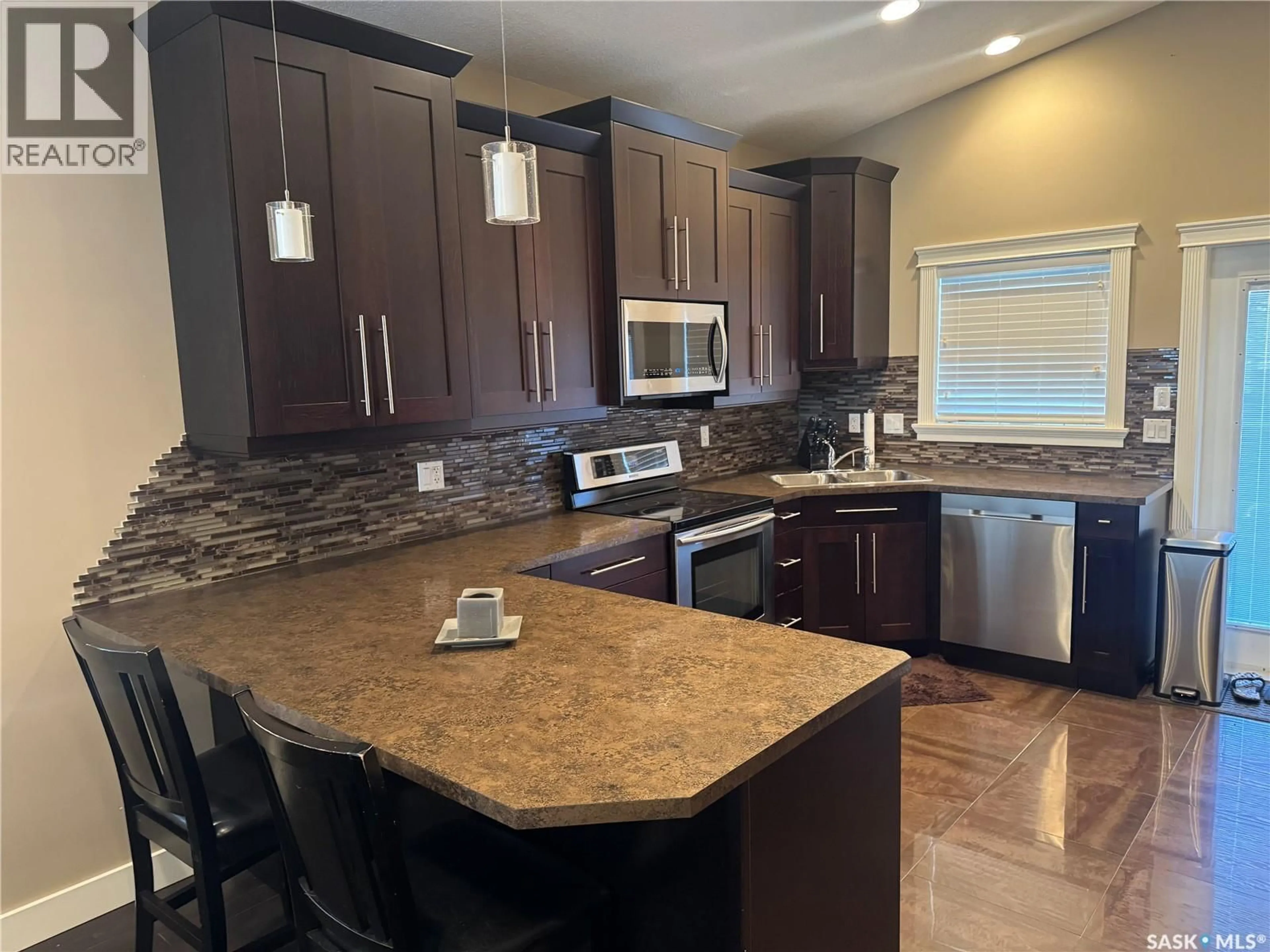 Open concept kitchen, ceramic/tile floor for 916 3RD STREET, Weyburn Saskatchewan S4H3J8