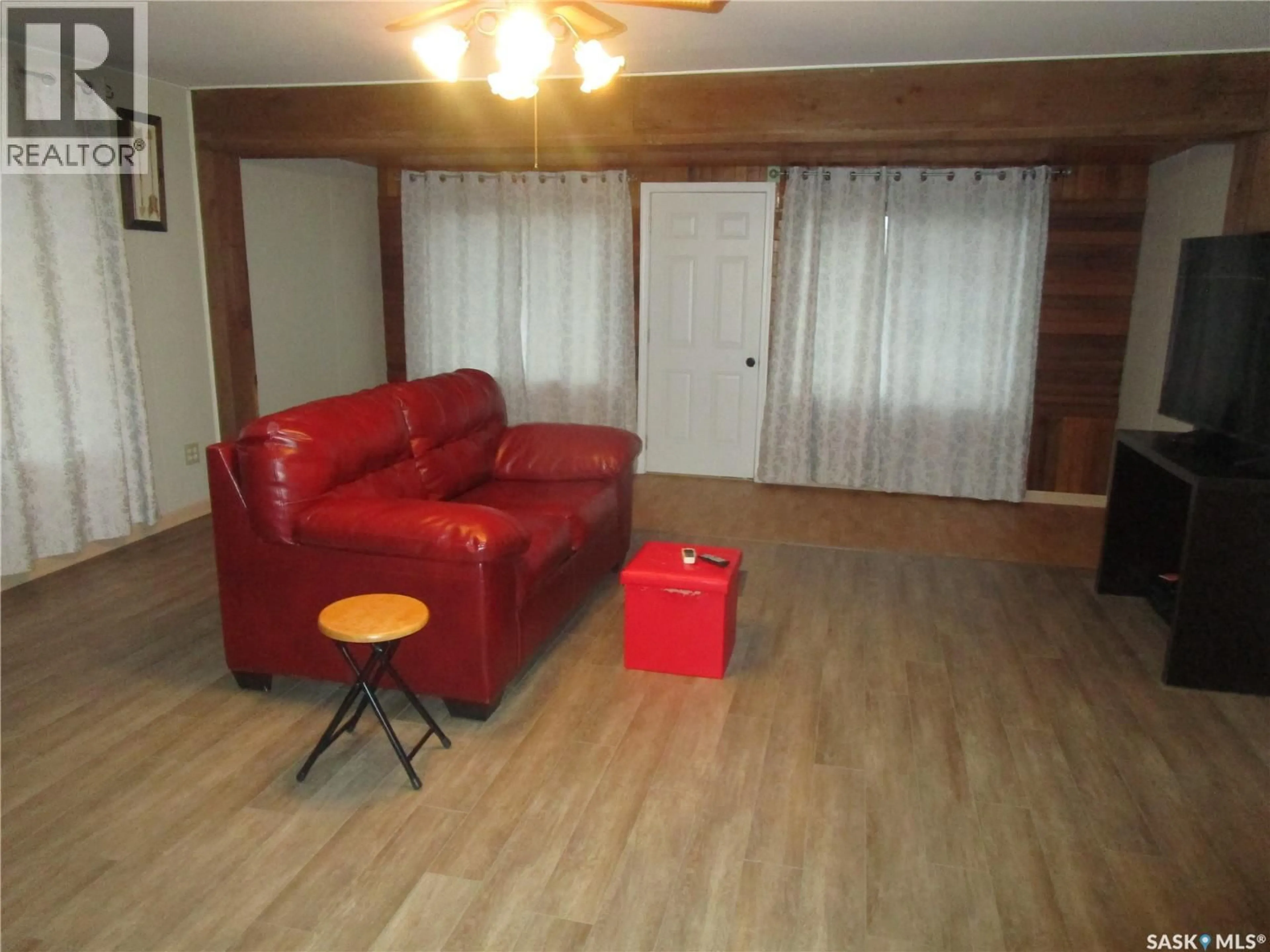 Living room with furniture, wood/laminate floor for 206 3RD AVENUE, Assiniboia Saskatchewan S0H0B0