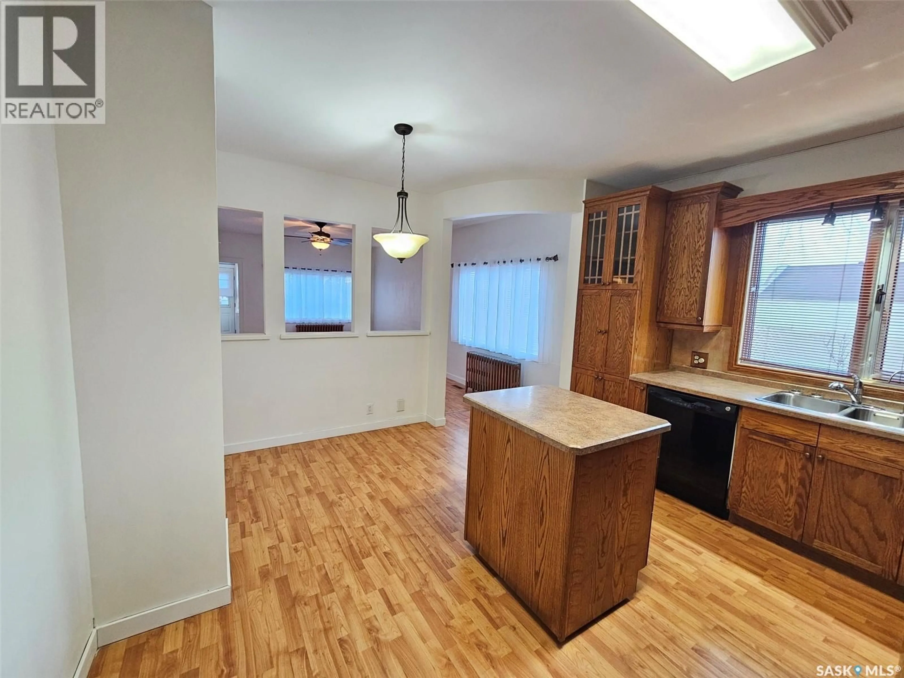 Open concept kitchen, wood/laminate floor for 201 SOURIS AVENUE, Carlyle Saskatchewan S0C0R0