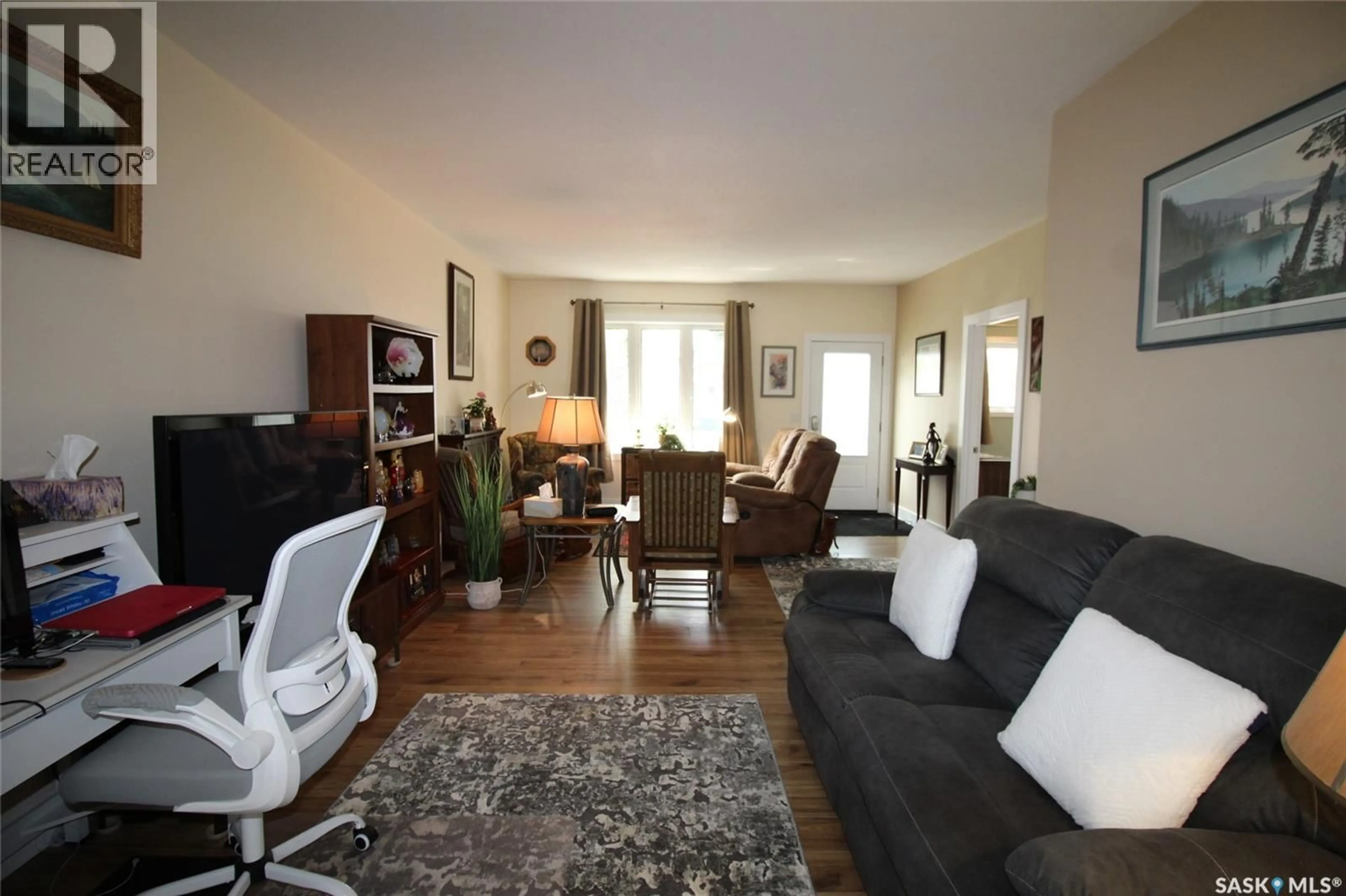 Living room with furniture, wood/laminate floor for 580 1ST STREET, Shaunavon Saskatchewan S0N2M0