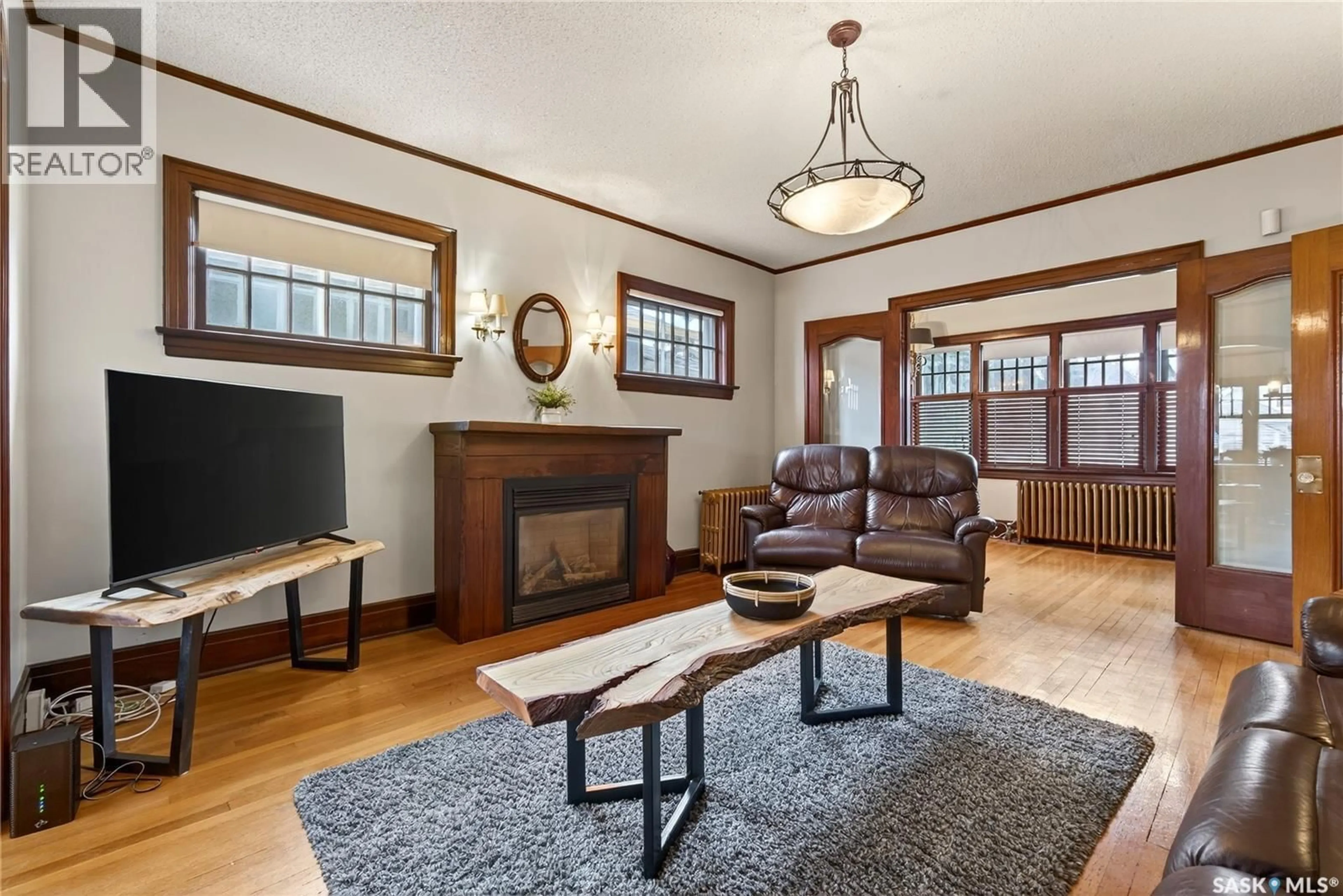 Living room with furniture, wood/laminate floor for 1334 VICTORIA AVENUE, Regina Saskatchewan S4P0P1