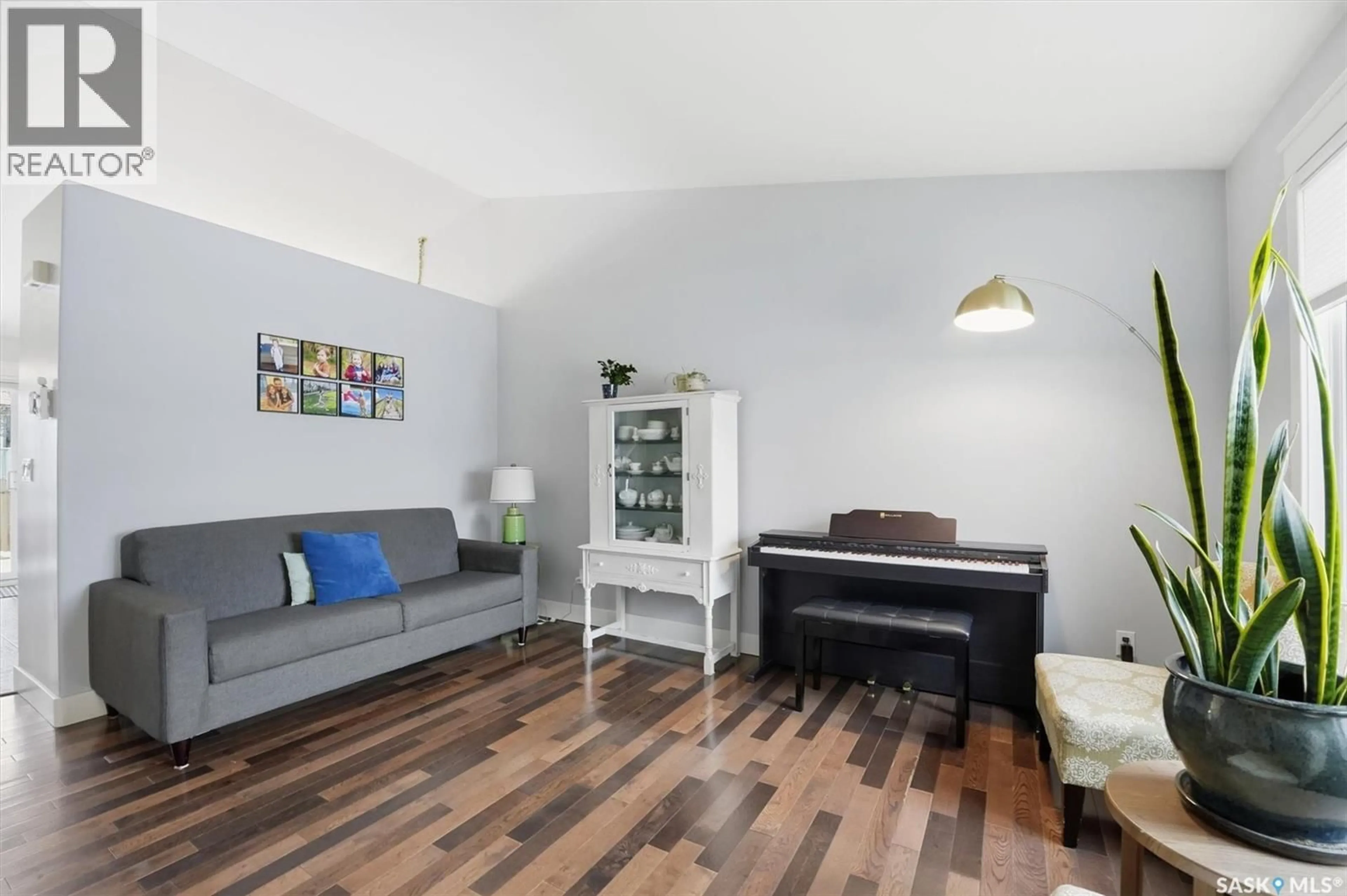 Living room with furniture, wood/laminate floor for 302 BUDZ CRESCENT, Saskatoon Saskatchewan S7N4M5