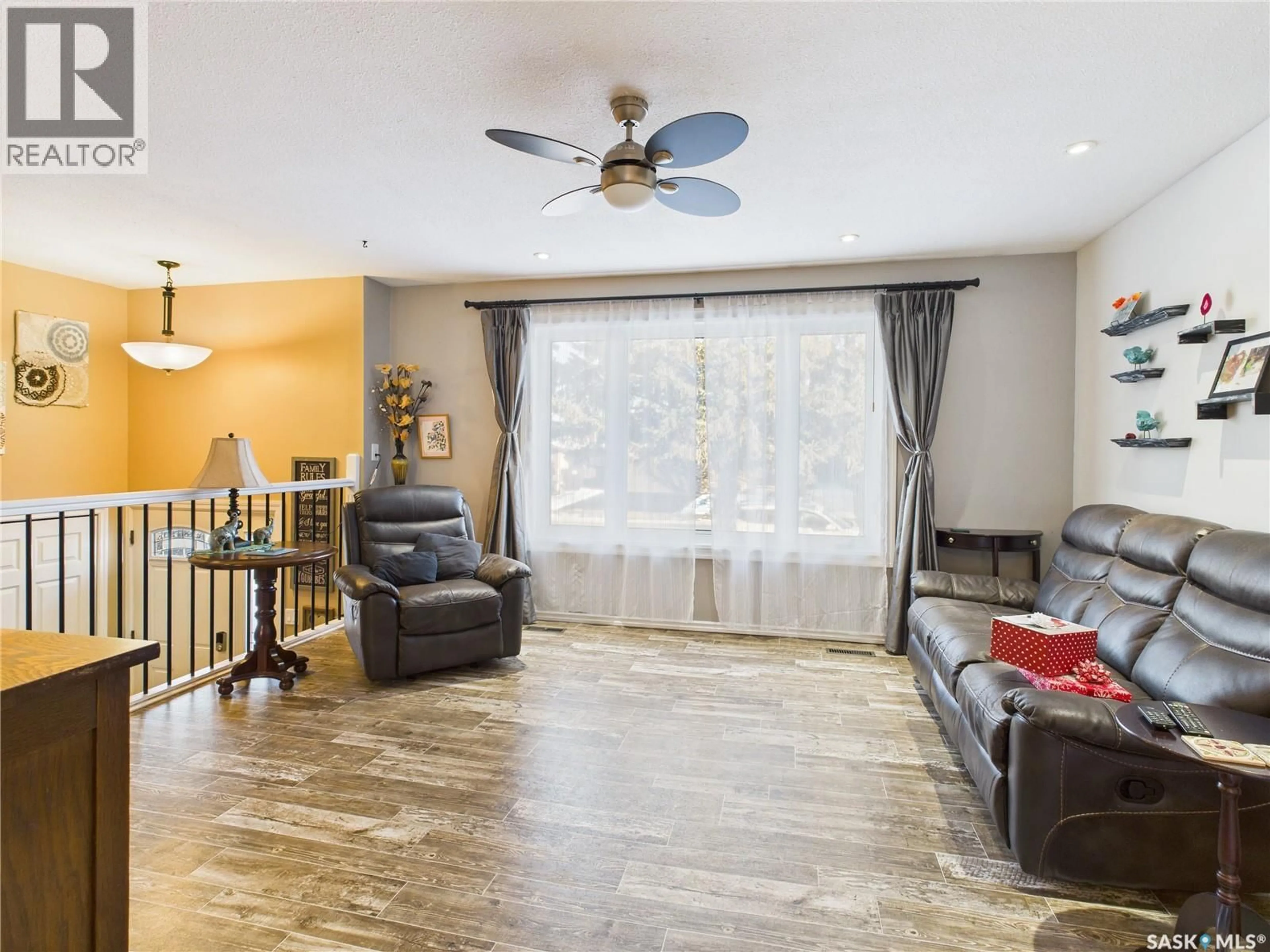 Living room with furniture, wood/laminate floor for 3441 12TH AVENUE, Prince Albert Saskatchewan S6V7G6