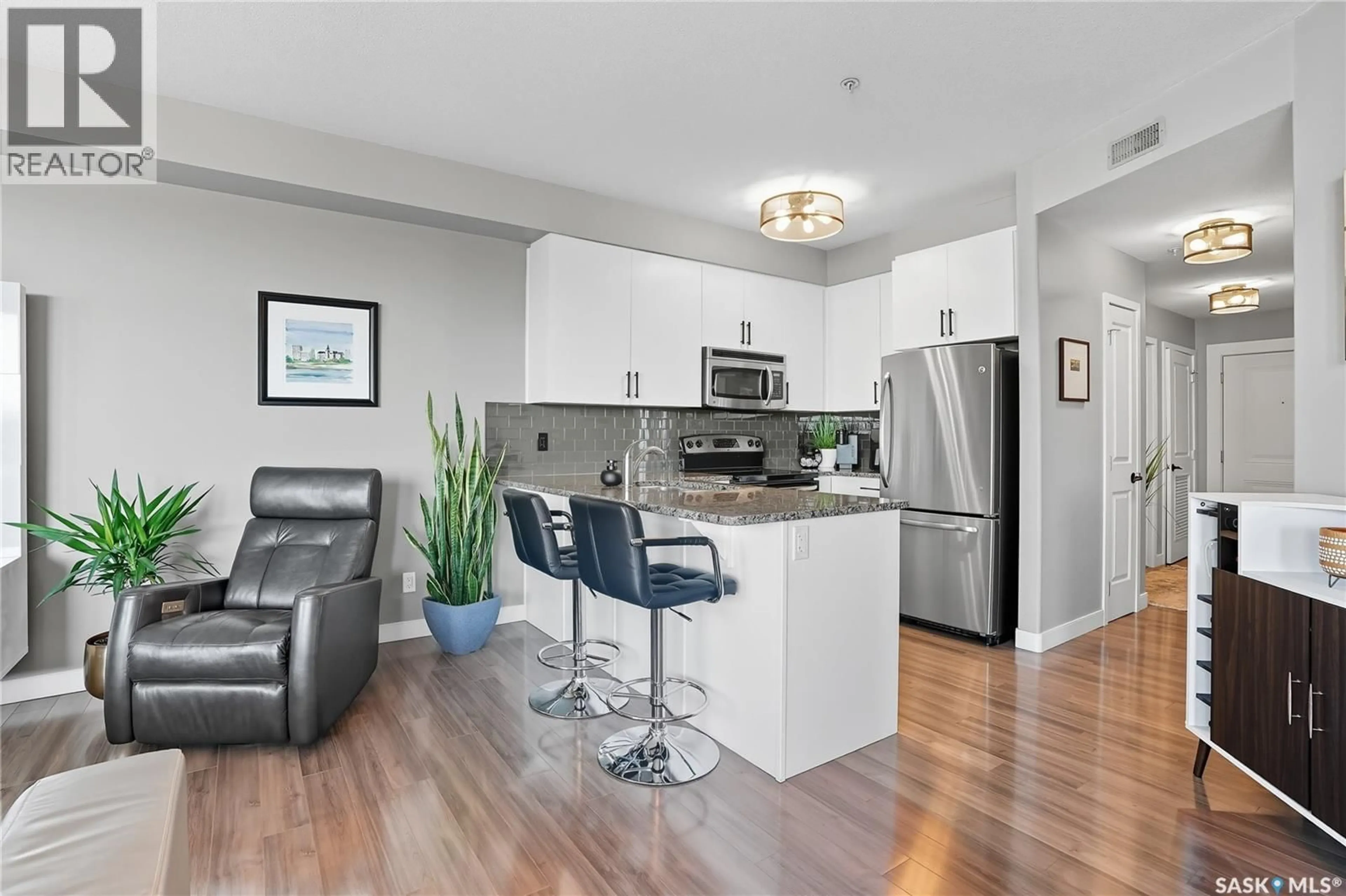 Open concept kitchen, wood/laminate floor for 201 158 PAWLYCHENKO LANE, Saskatoon Saskatchewan S7V0C3