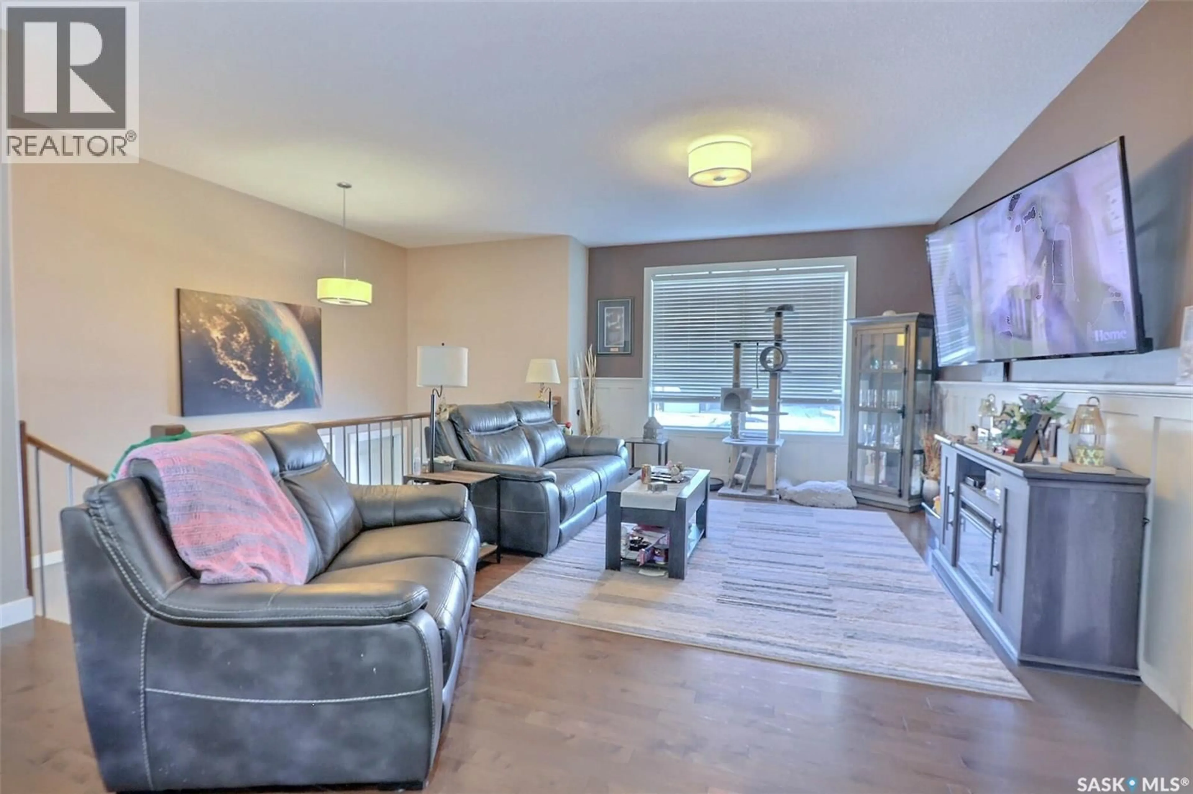 Living room with furniture, wood/laminate floor for 11 HADLEY ROAD, Prince Albert Saskatchewan S6X0A5