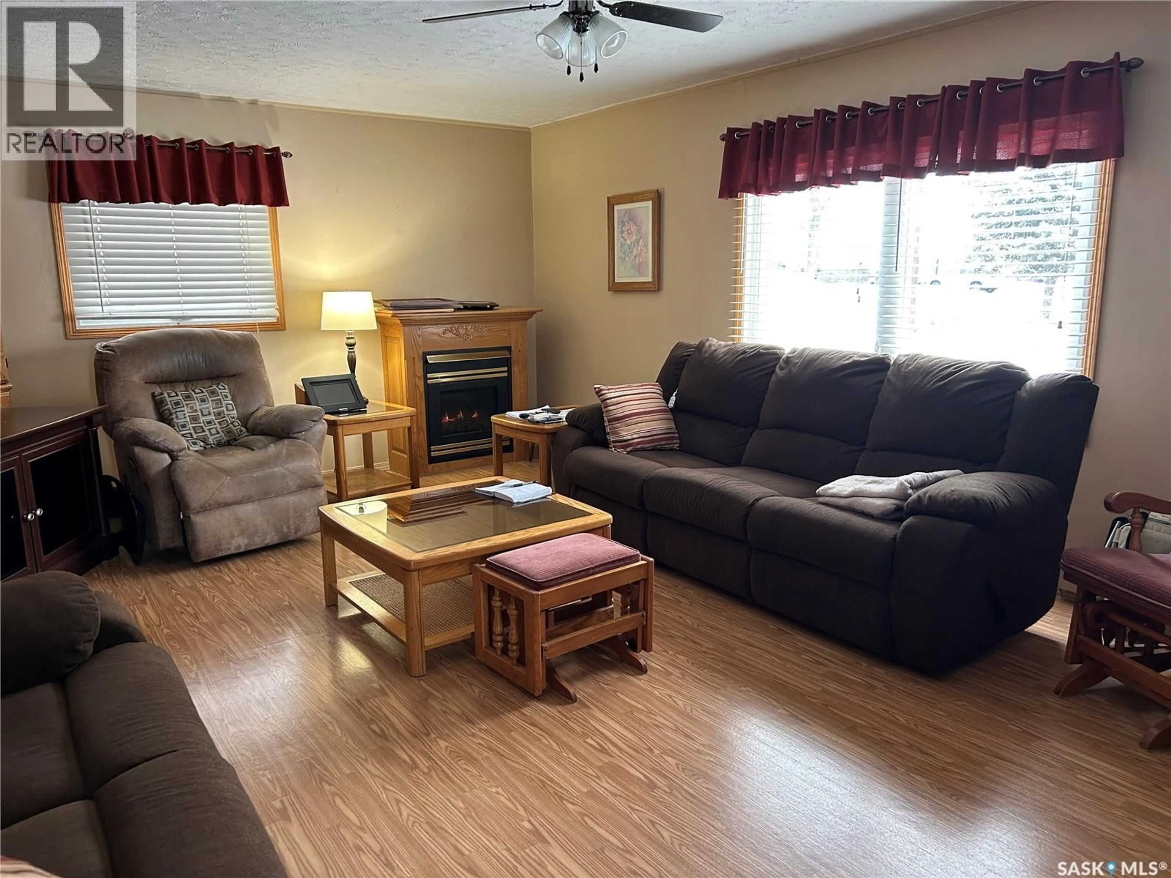 Living room with furniture, wood/laminate floor for 902 EVA STREET, Estevan Saskatchewan S4A1P5