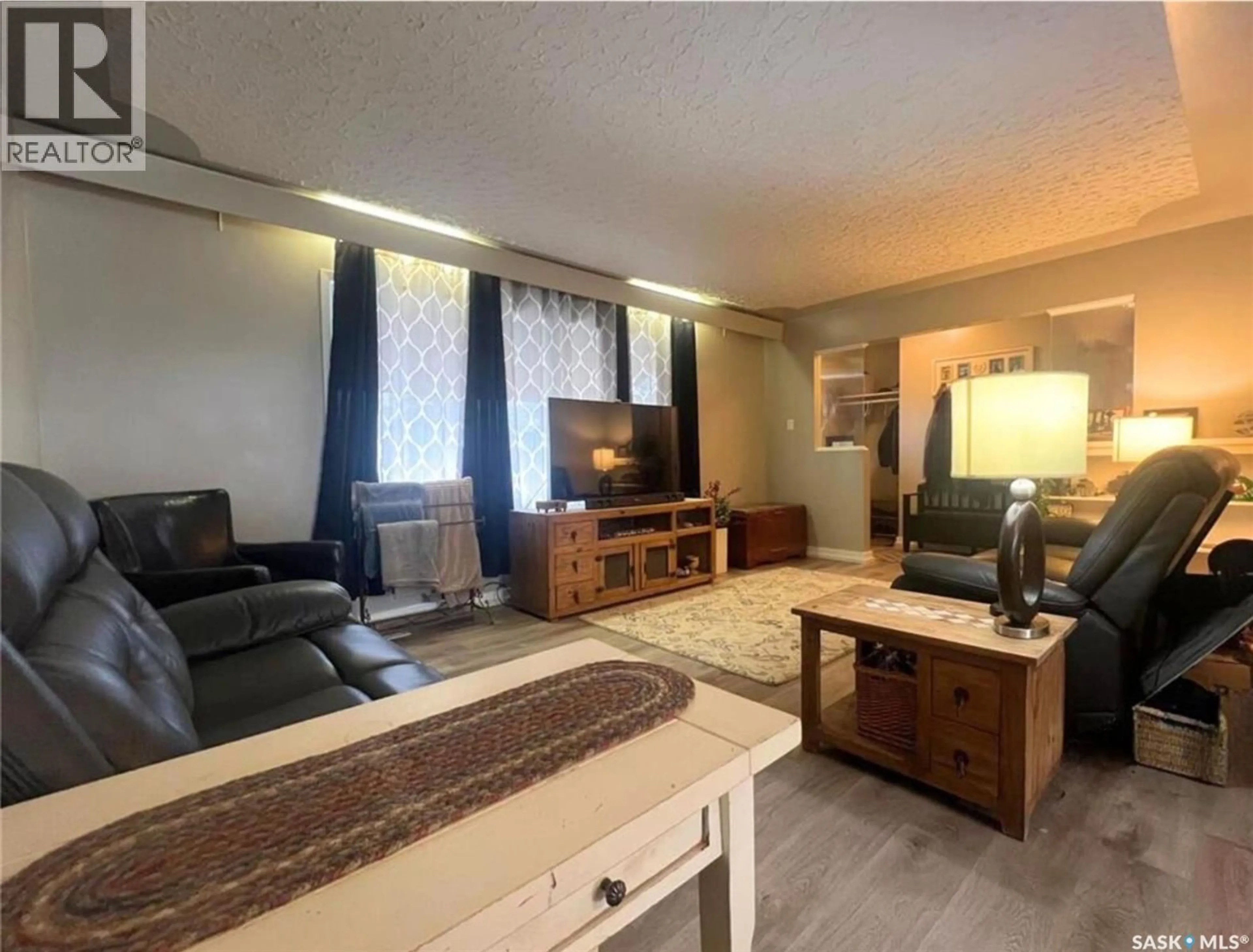 Living room with furniture, wood/laminate floor for 437 4TH AVENUE, Swift Current Saskatchewan S9H0V3