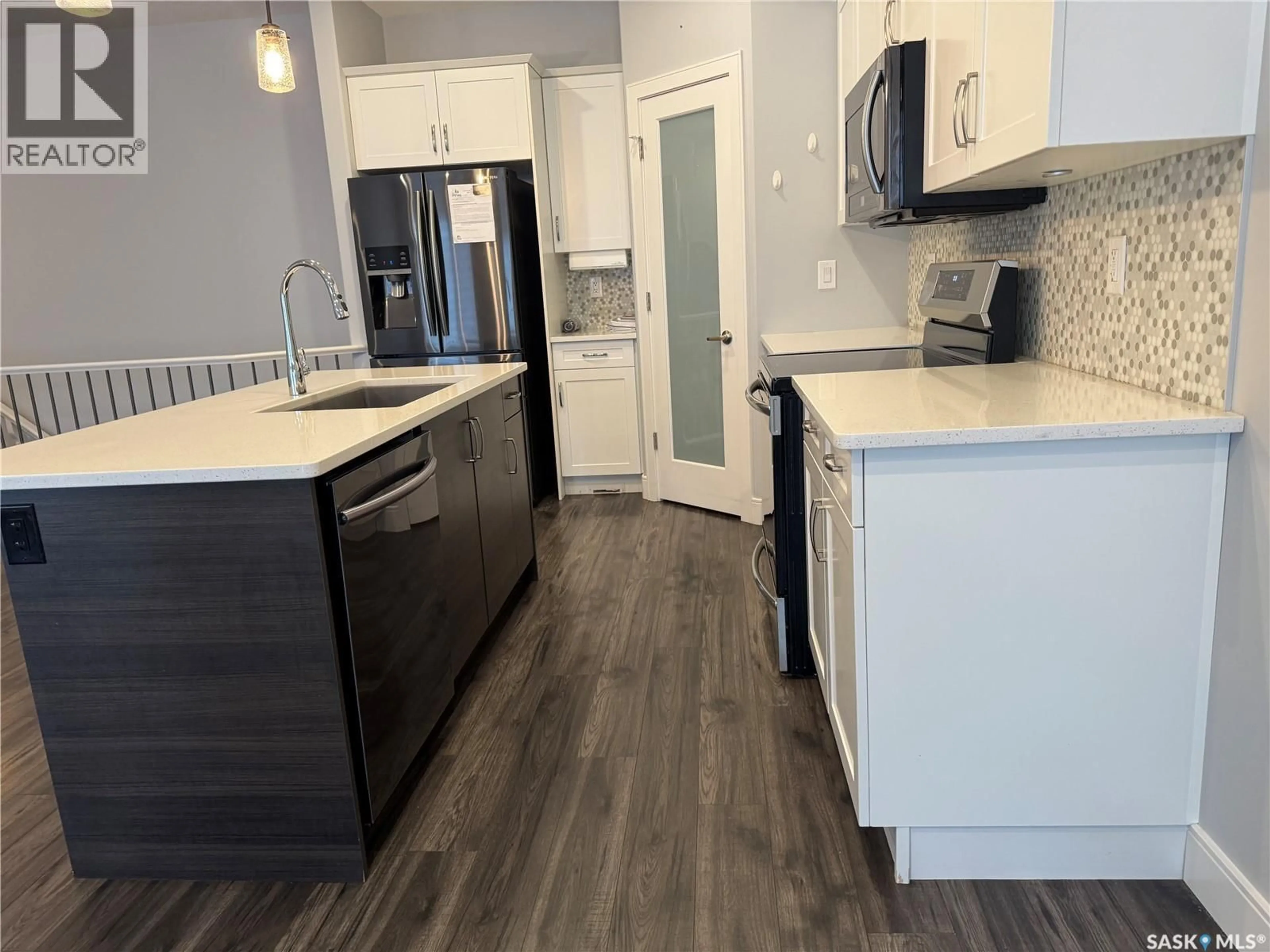 Open concept kitchen, wood/laminate floor for 21 103 POHORECKY CRESCENT, Saskatoon Saskatchewan S7W0X6