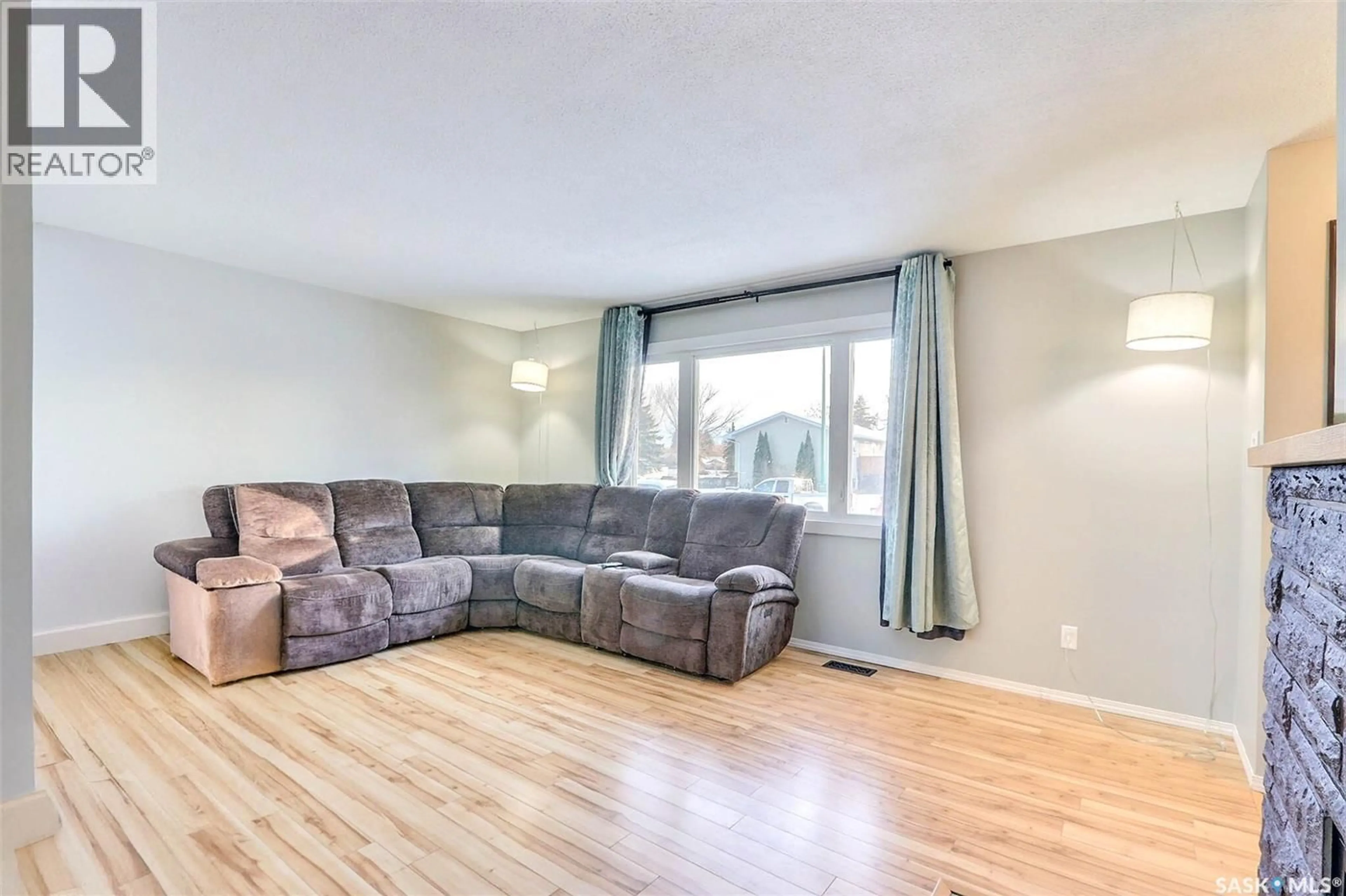 Living room with furniture, wood/laminate floor for 978 FRASER PLACE, Prince Albert Saskatchewan S6V2T7