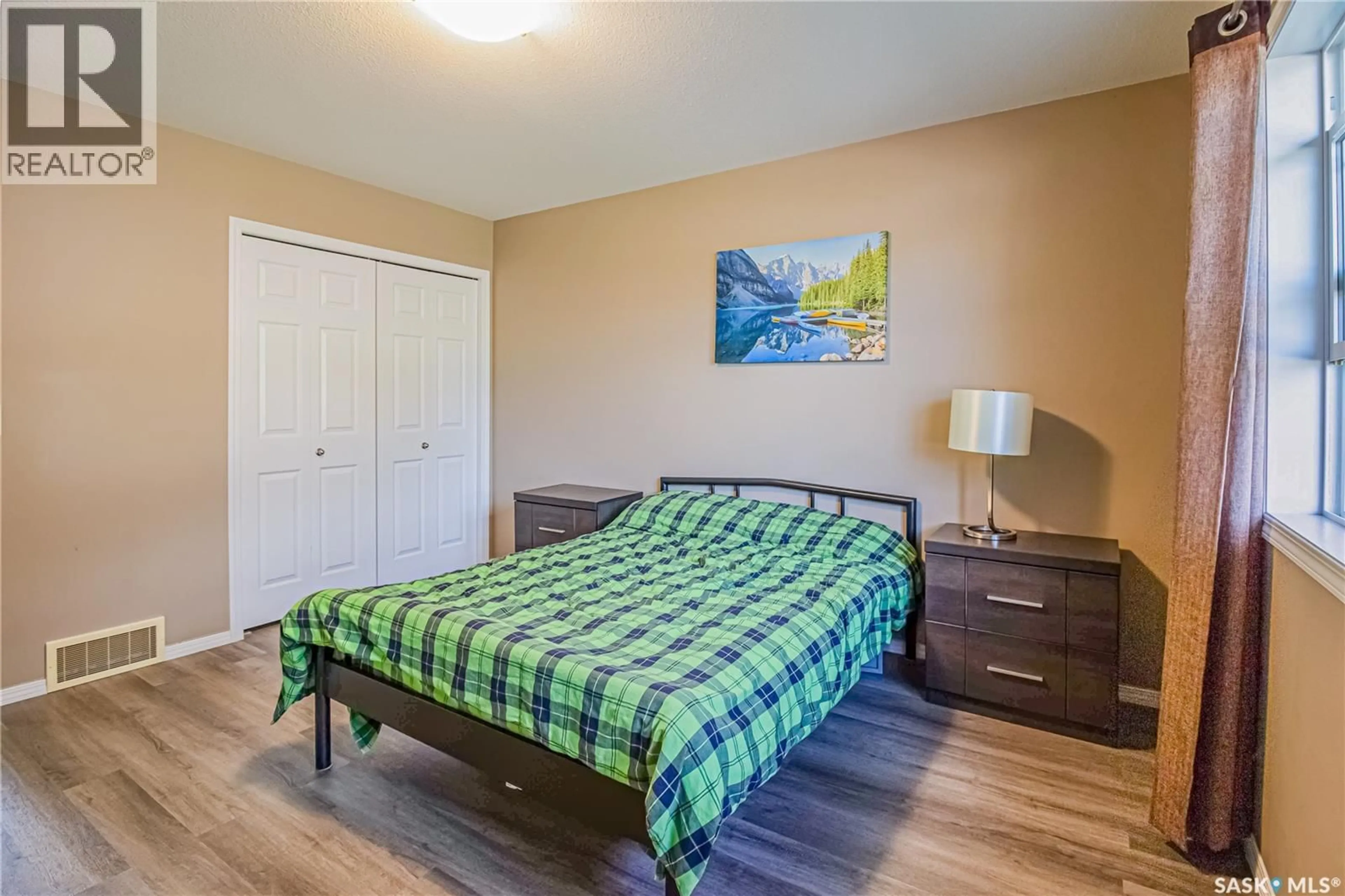 Bedroom with bed, wood/laminate floor for 410 - 121 STENSRUD ROAD, Saskatoon Saskatchewan S7W0B7