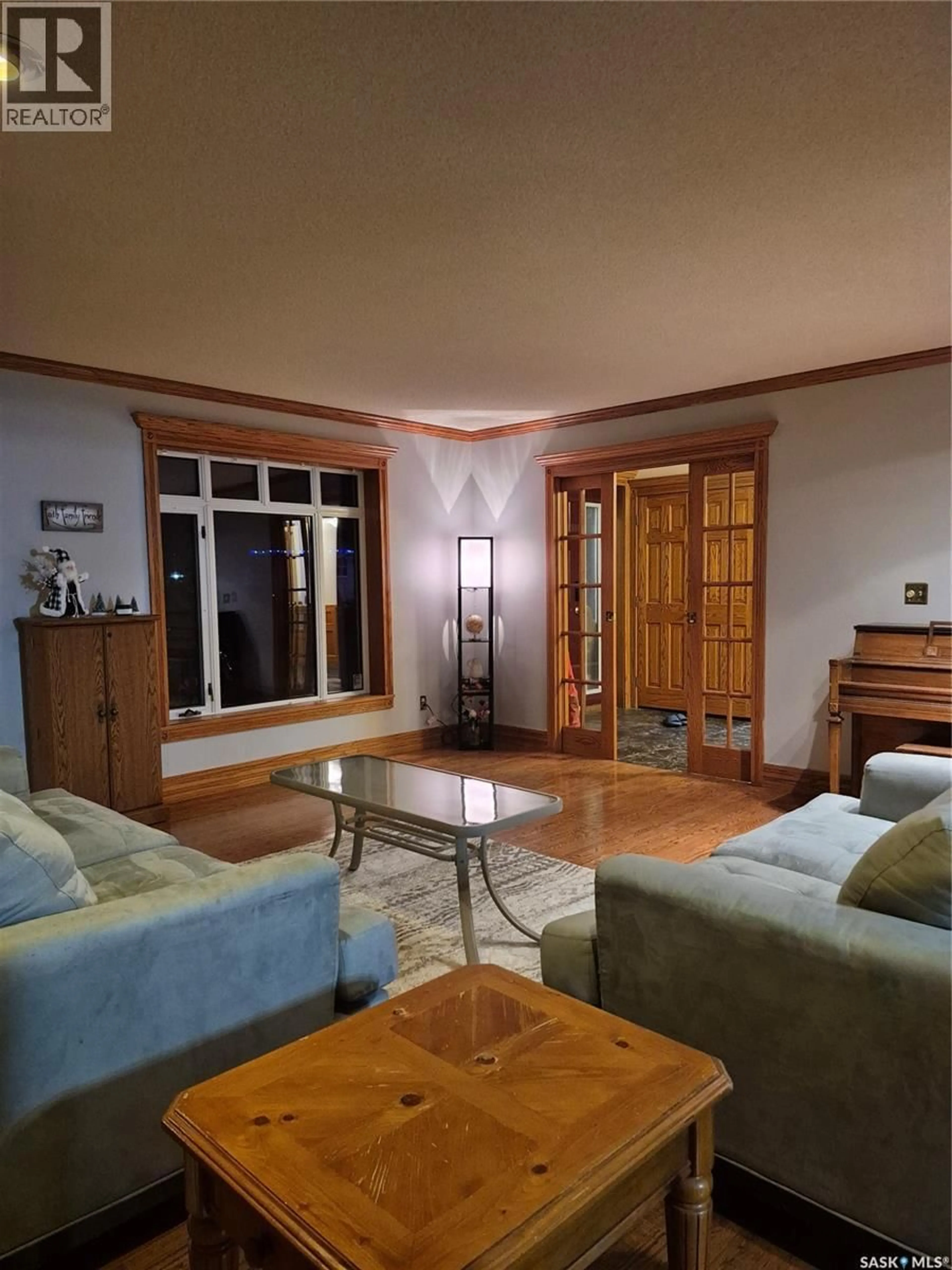 Living room with furniture, wood/laminate floor for 1809 THIRD STREET, Estevan Saskatchewan S4A0T1