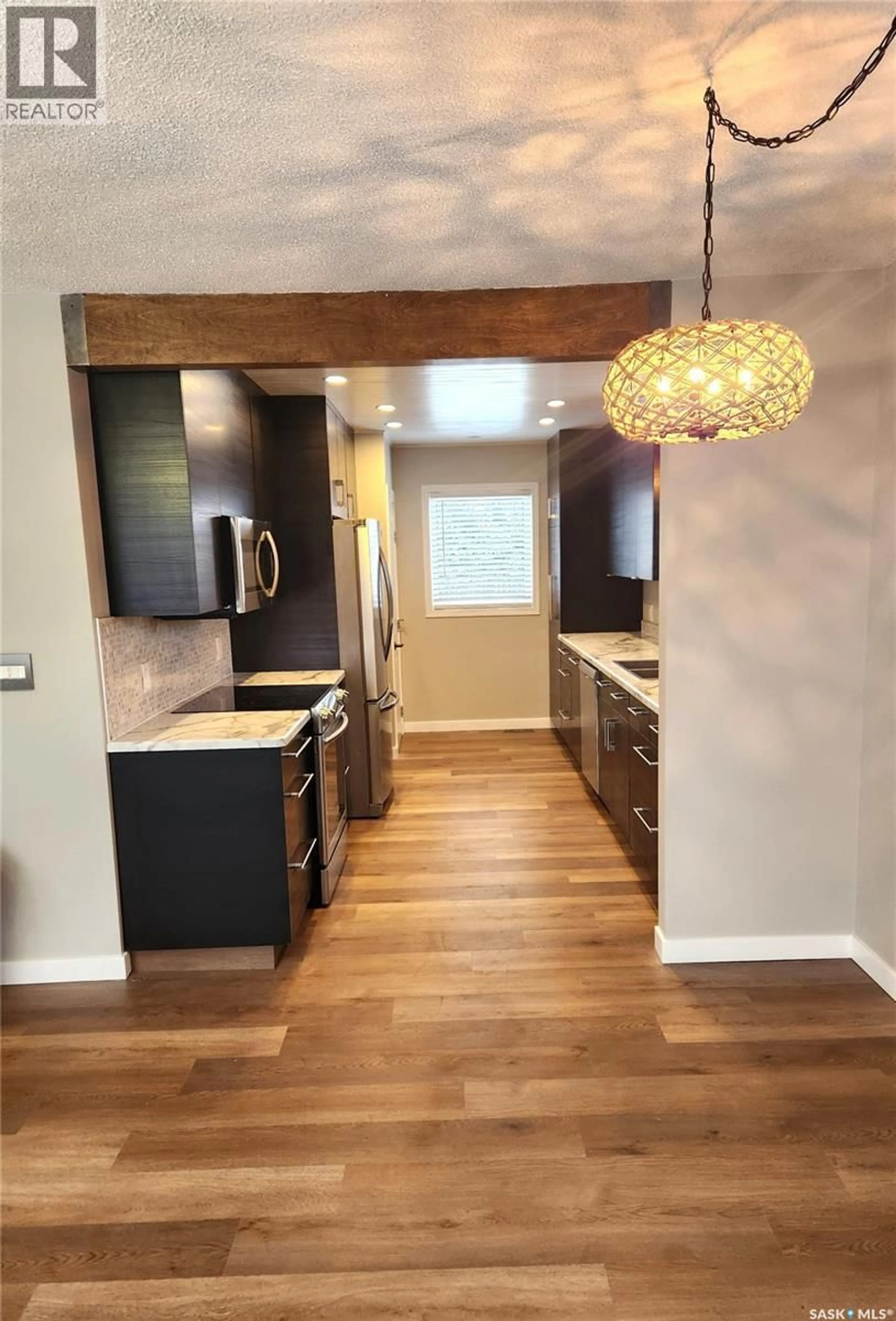 Open concept kitchen, wood/laminate floor for 1533 YOUNG STREET, Estevan Saskatchewan S4A0J5