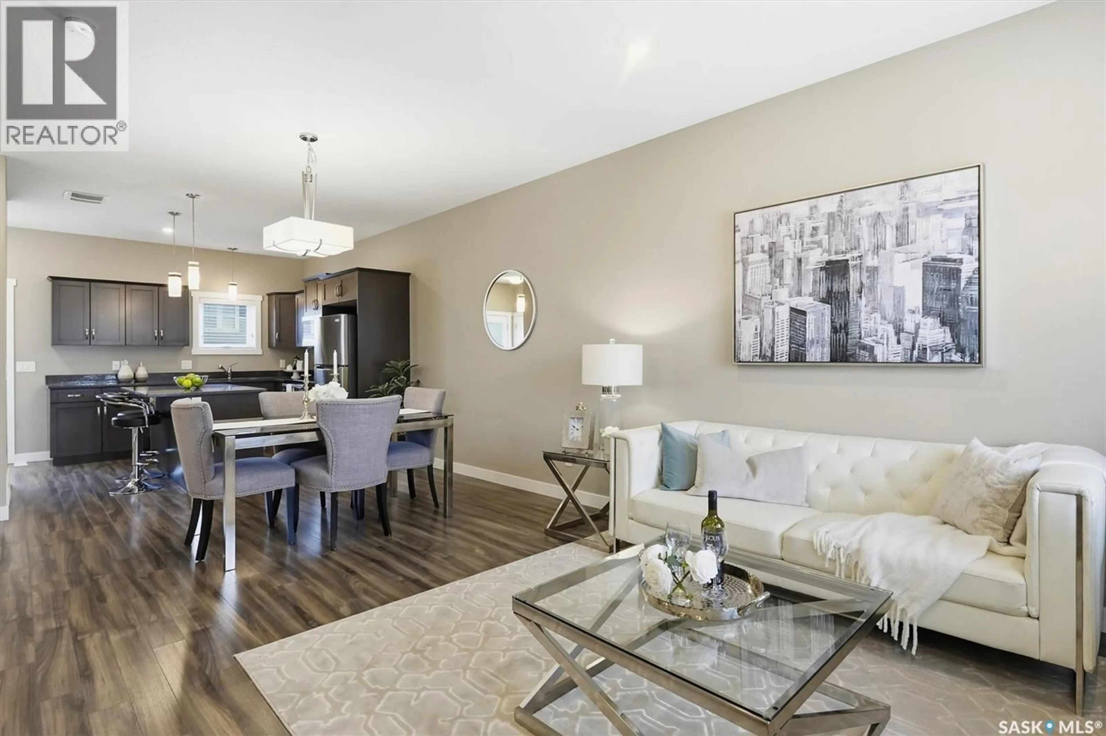 Living room with furniture, wood/laminate floor for 1216 PRINGLE WAY, Saskatoon Saskatchewan S7T0X5