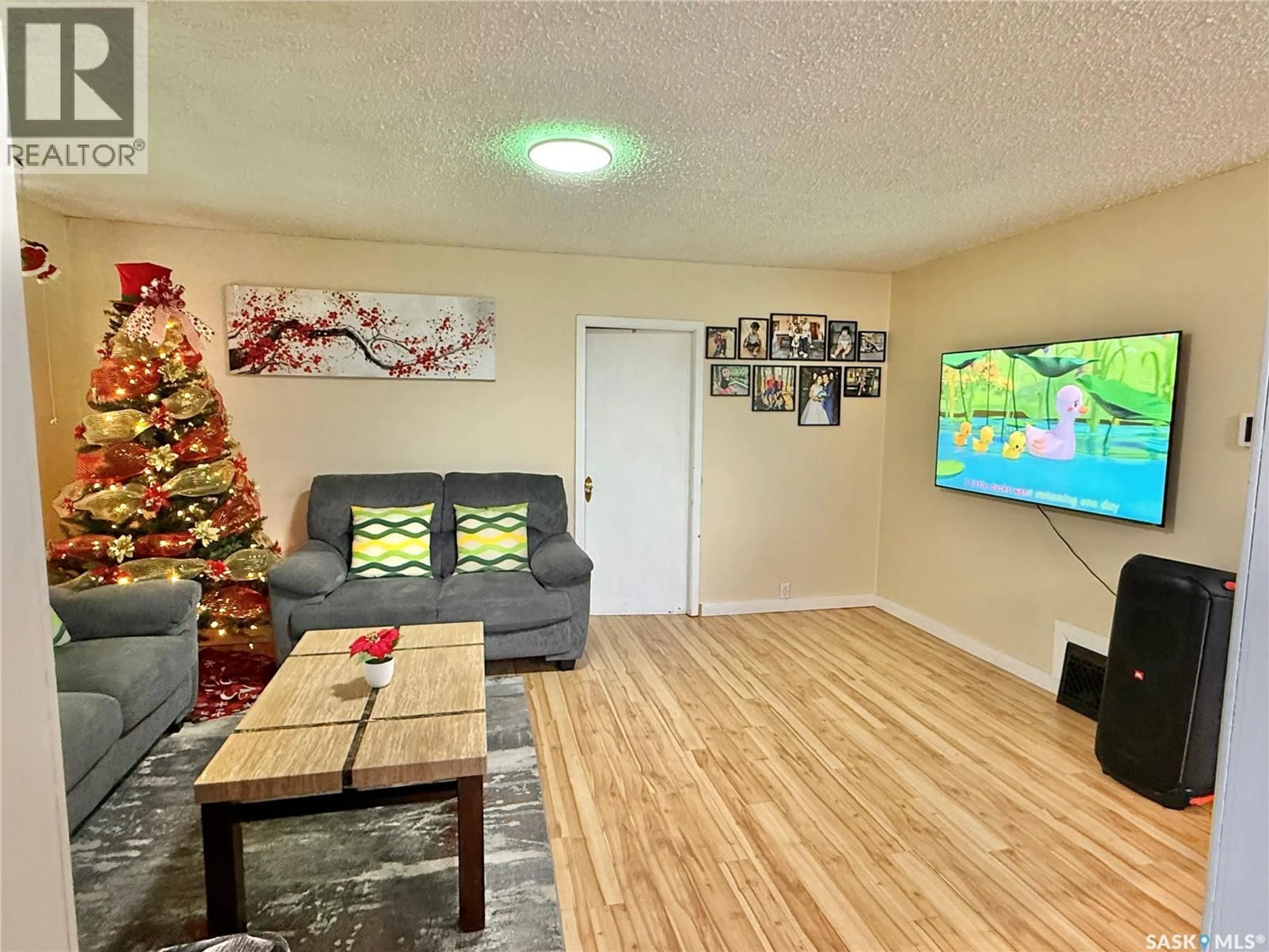 Living room with furniture, wood/laminate floor for E - 205 1ST STREET, Spiritwood Saskatchewan S0J2M0