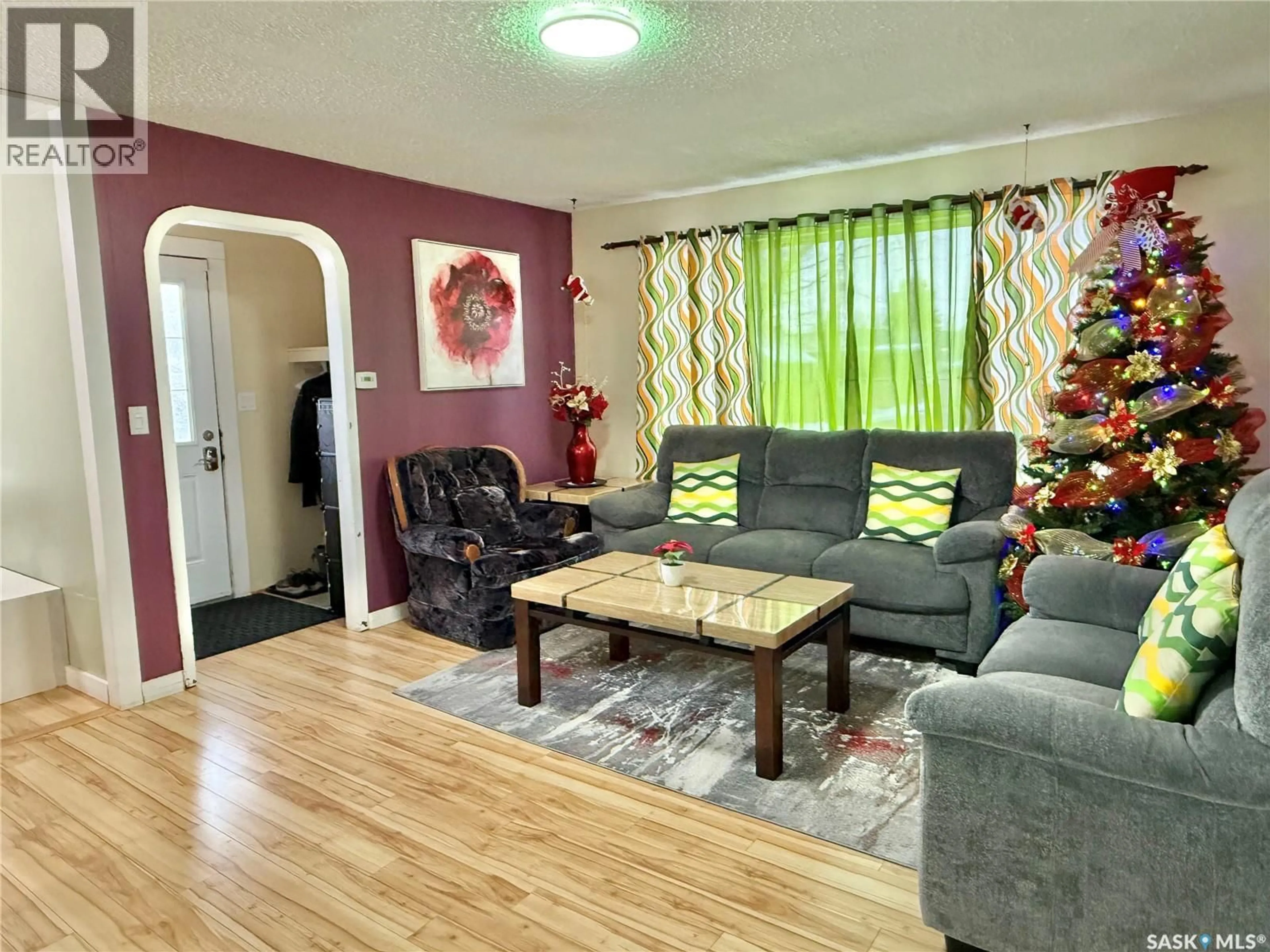 Living room with furniture, wood/laminate floor for E - 205 1ST STREET, Spiritwood Saskatchewan S0J2M0