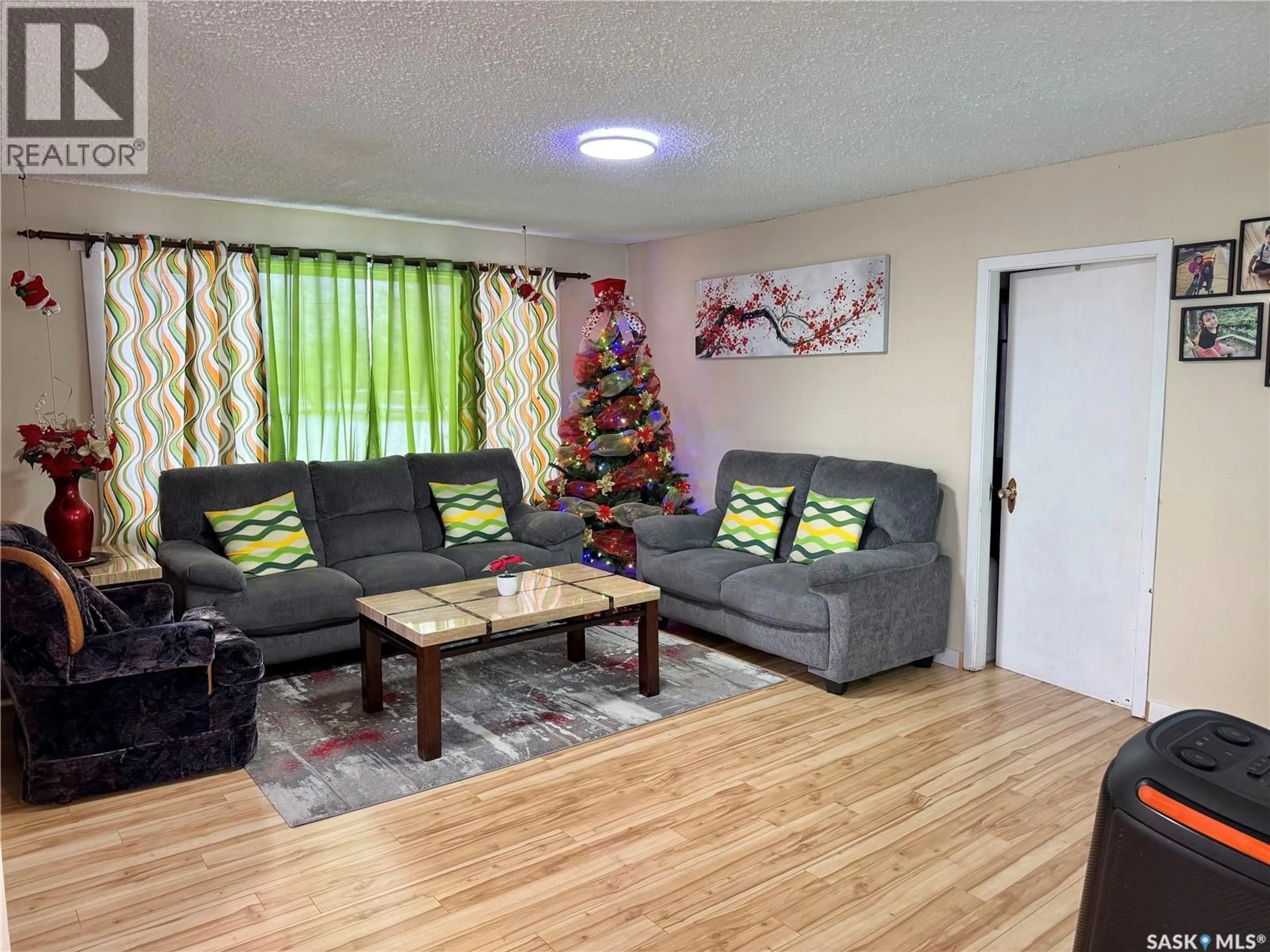 Living room with furniture, wood/laminate floor for E - 205 1ST STREET, Spiritwood Saskatchewan S0J2M0