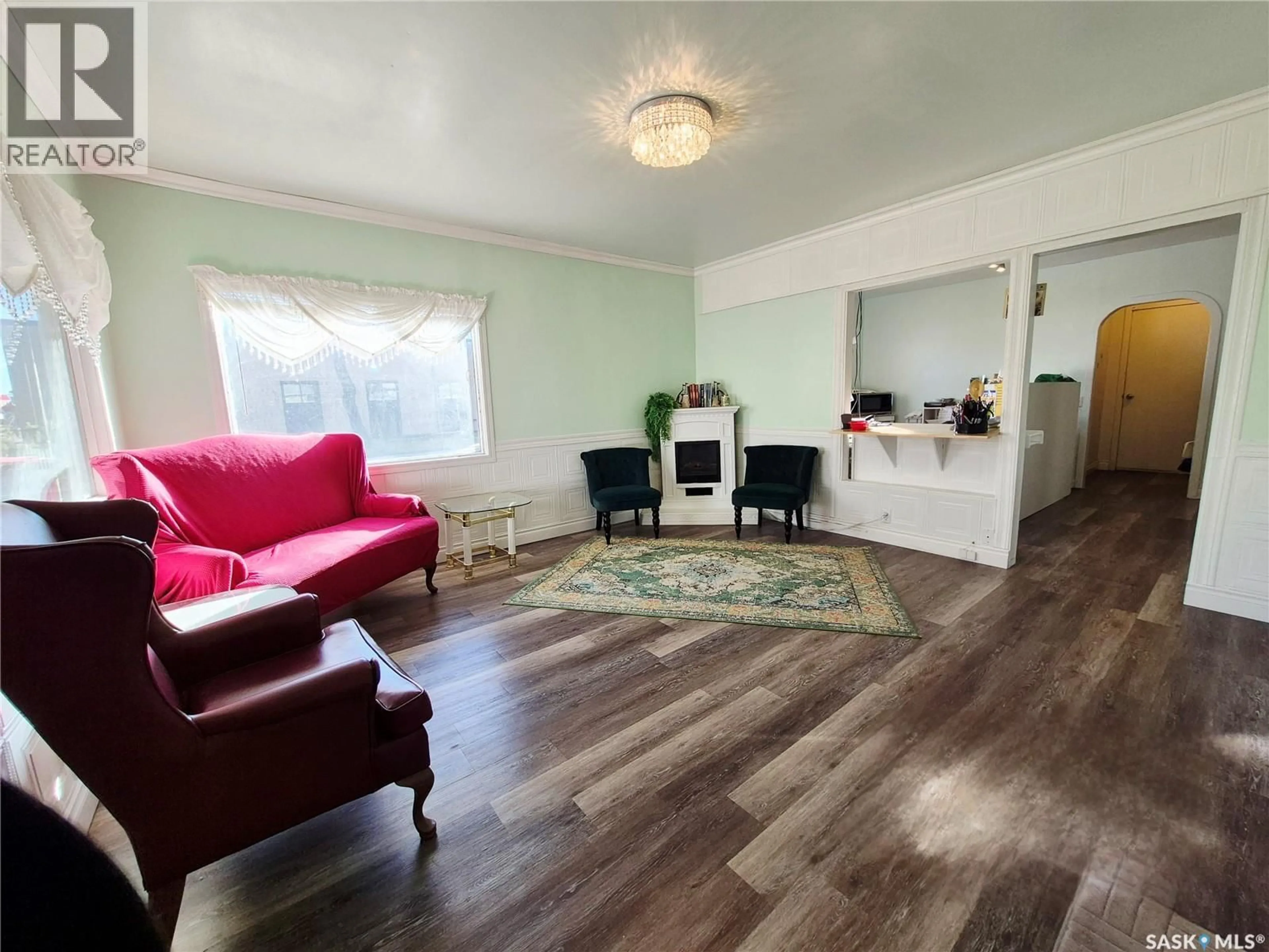 Living room with furniture, wood/laminate floor for 505 CENTRE STREET, Shaunavon Saskatchewan S0N2M0