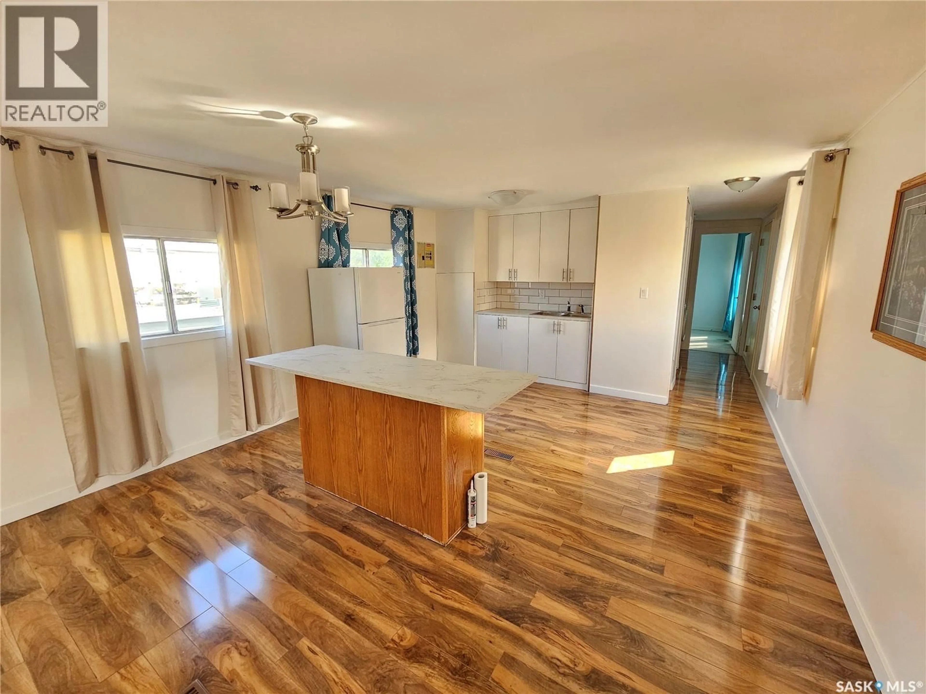 Open concept kitchen, wood/laminate floor for 410 7TH AVENUE, Meadow Lake Saskatchewan S9X1C1