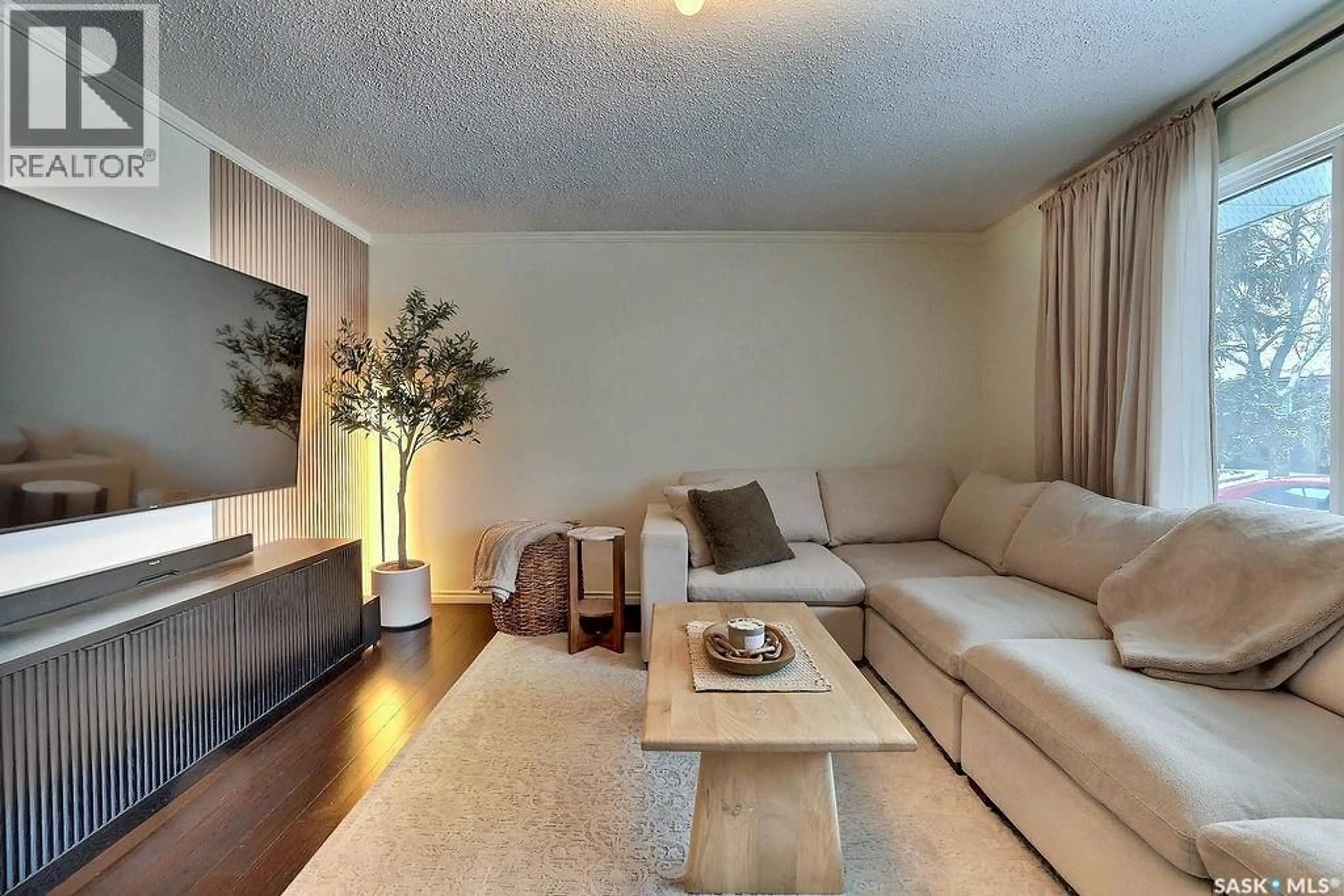 Living room with furniture, wood/laminate floor for 66 SNEATH CRESCENT, Regina Saskatchewan S4R5P9