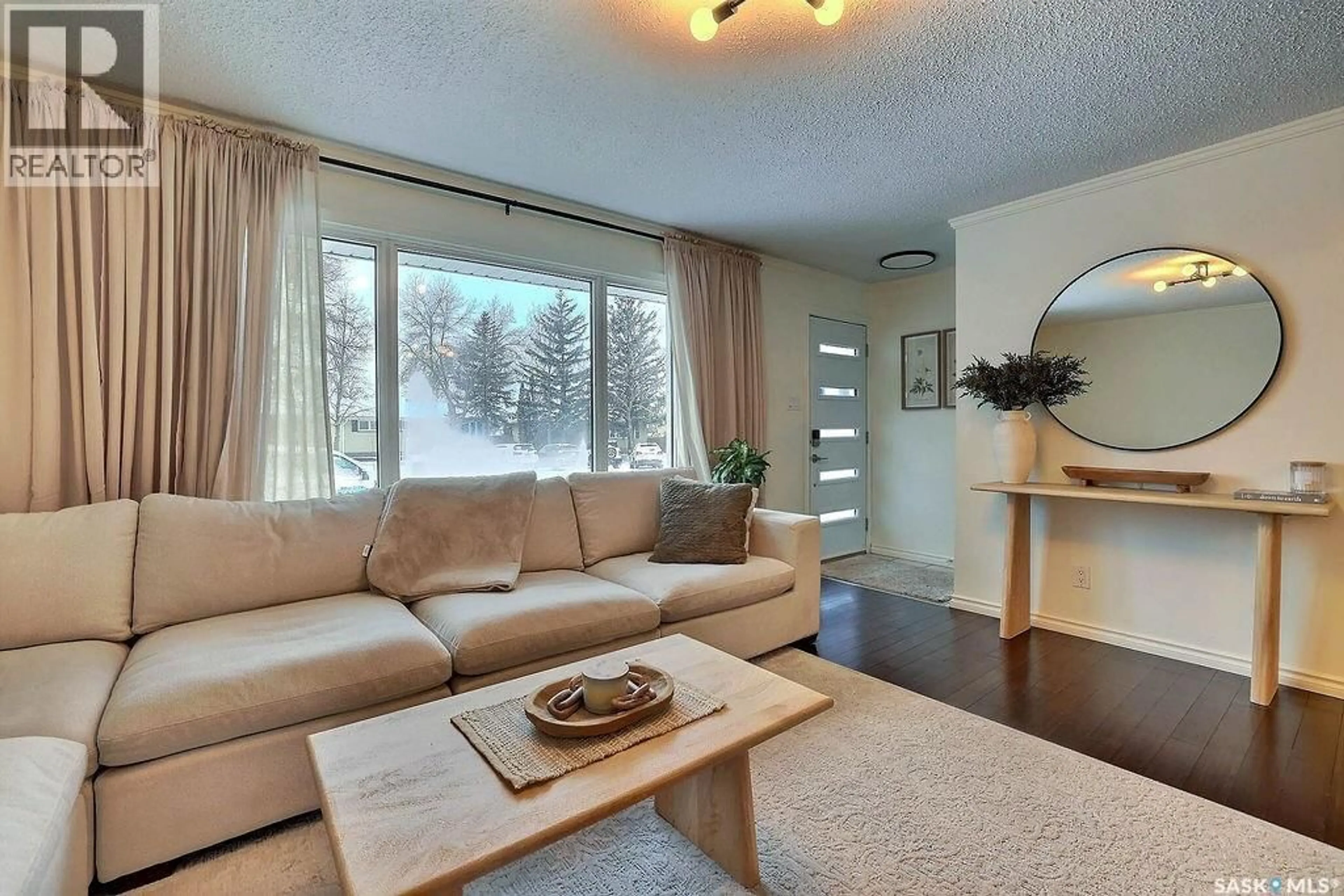 Living room with furniture, wood/laminate floor for 66 SNEATH CRESCENT, Regina Saskatchewan S4R5P9