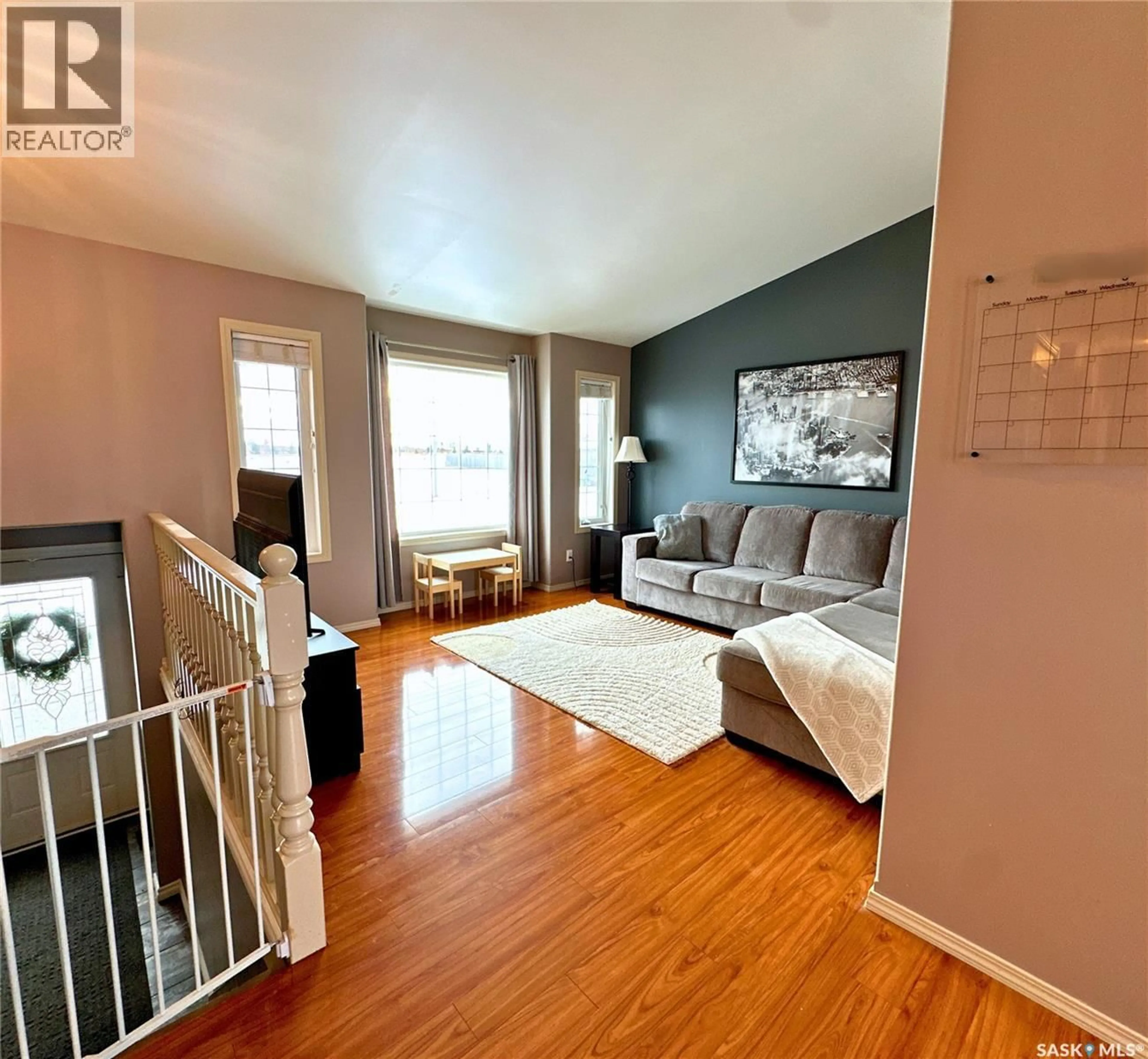 Living room with furniture, wood/laminate floor for 9 POPLAR CRESCENT, Birch Hills Saskatchewan S0J0G0