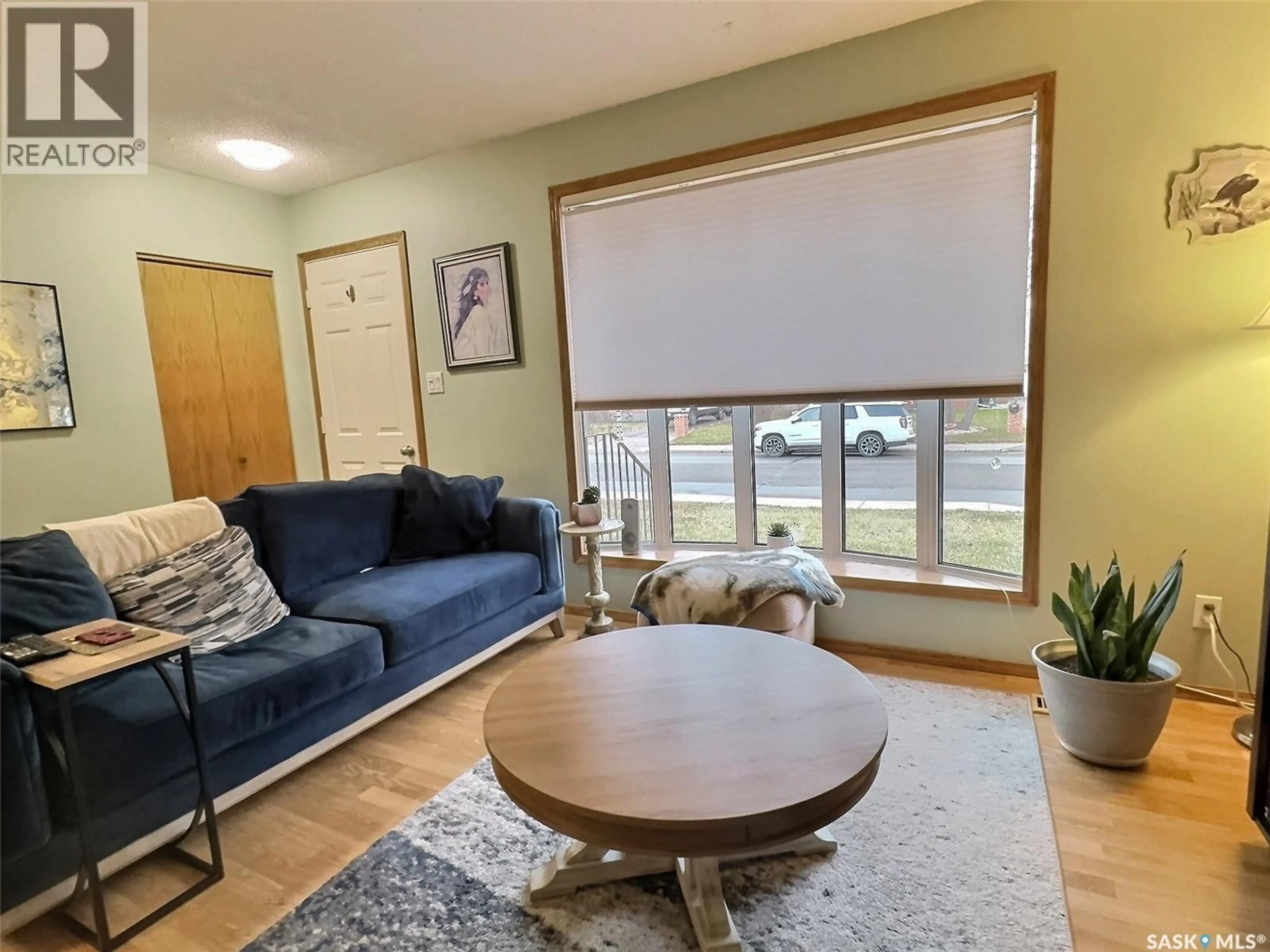 Living room with furniture, wood/laminate floor for 127 MCDONALD ROAD, Estevan Saskatchewan S4A0B9