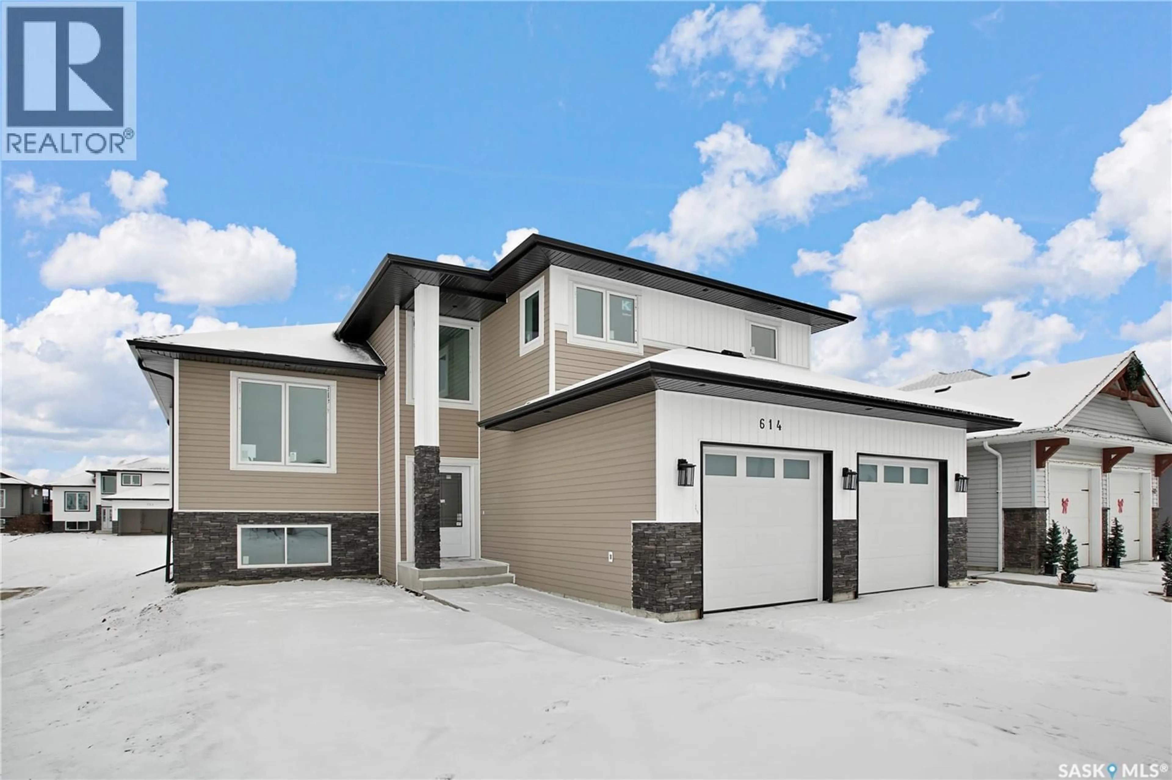 Home with vinyl exterior material, street for 614 CASPER COVE, Warman Saskatchewan S0K4S4