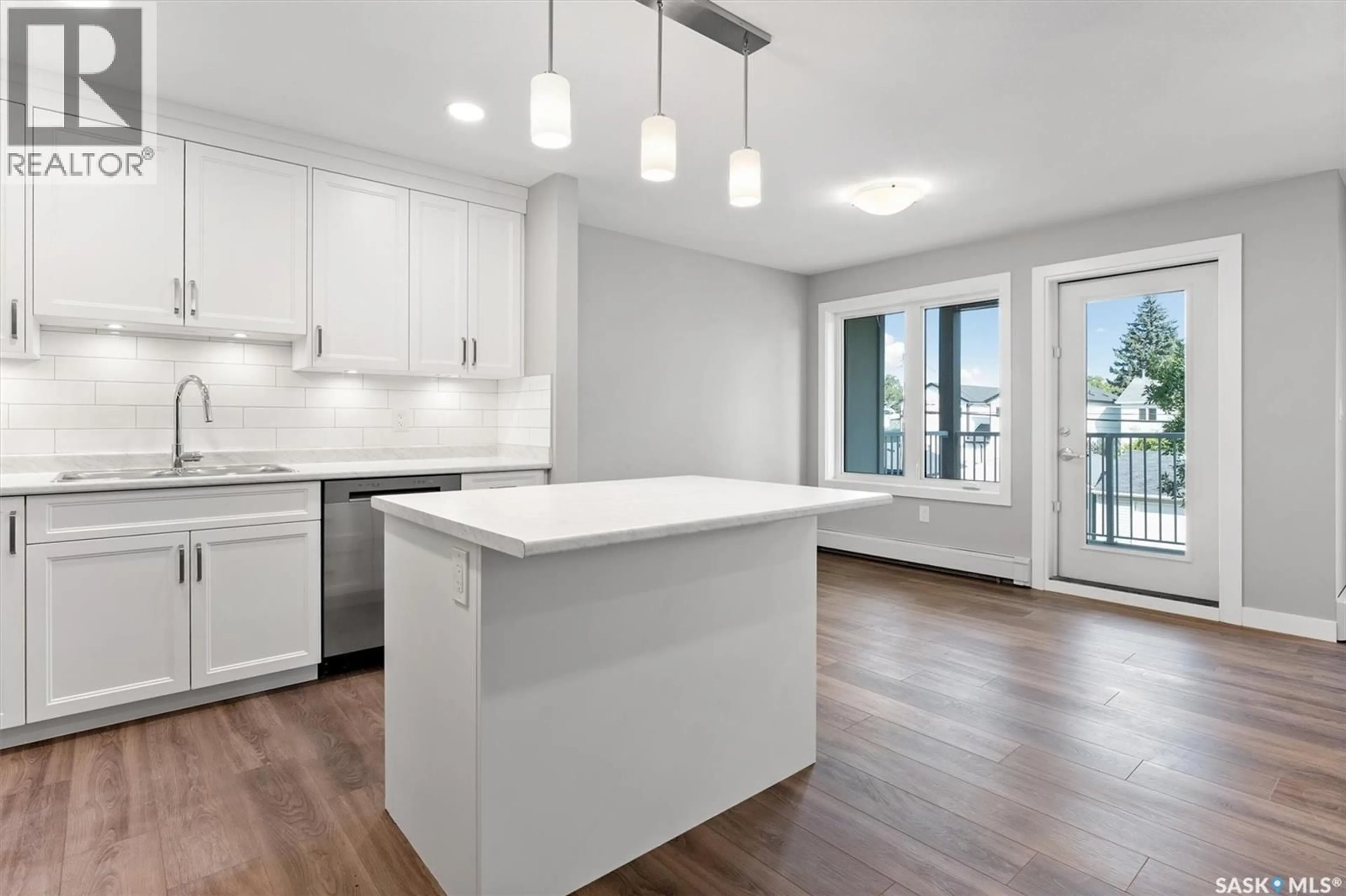 Open concept kitchen, wood/laminate floor for 202 318 108TH STREET, Saskatoon Saskatchewan S7N1P8