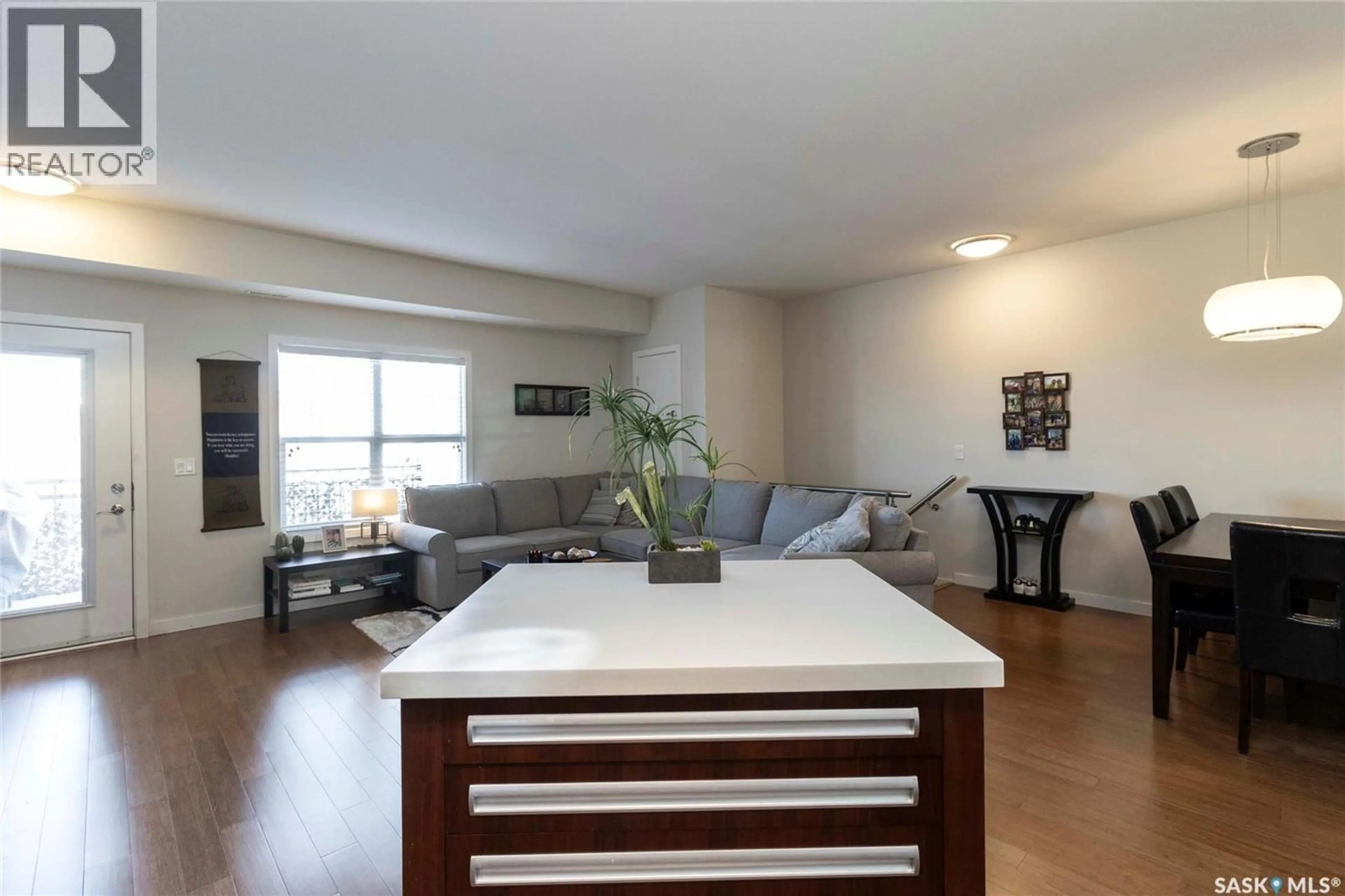 Living room with furniture, wood/laminate floor for 1015 - 2208 PATRICK CRESCENT, Saskatoon Saskatchewan S7W0M1