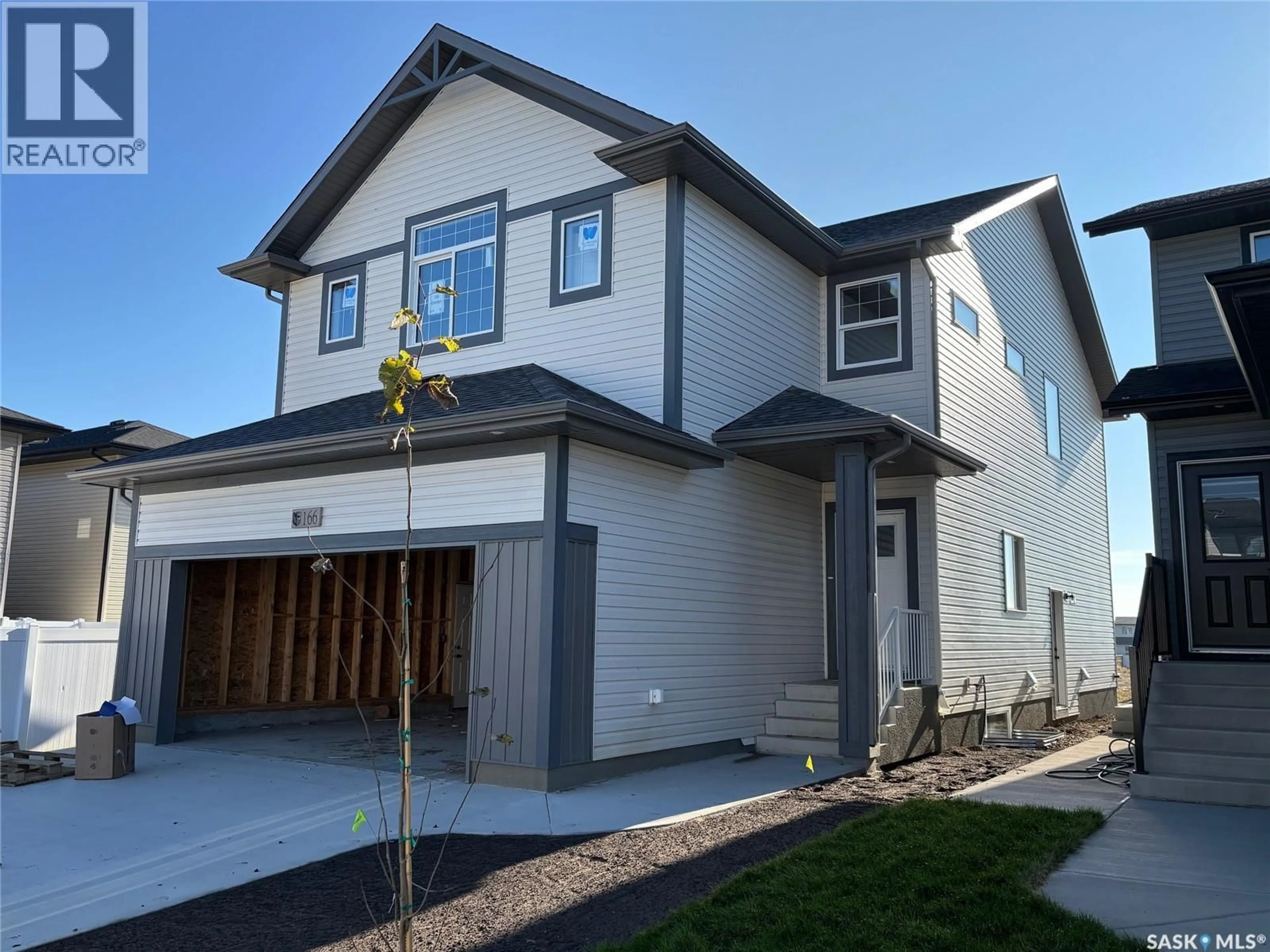 Home with vinyl exterior material, street for 166 DORAN WAY, Saskatoon Saskatchewan S7V0Z7