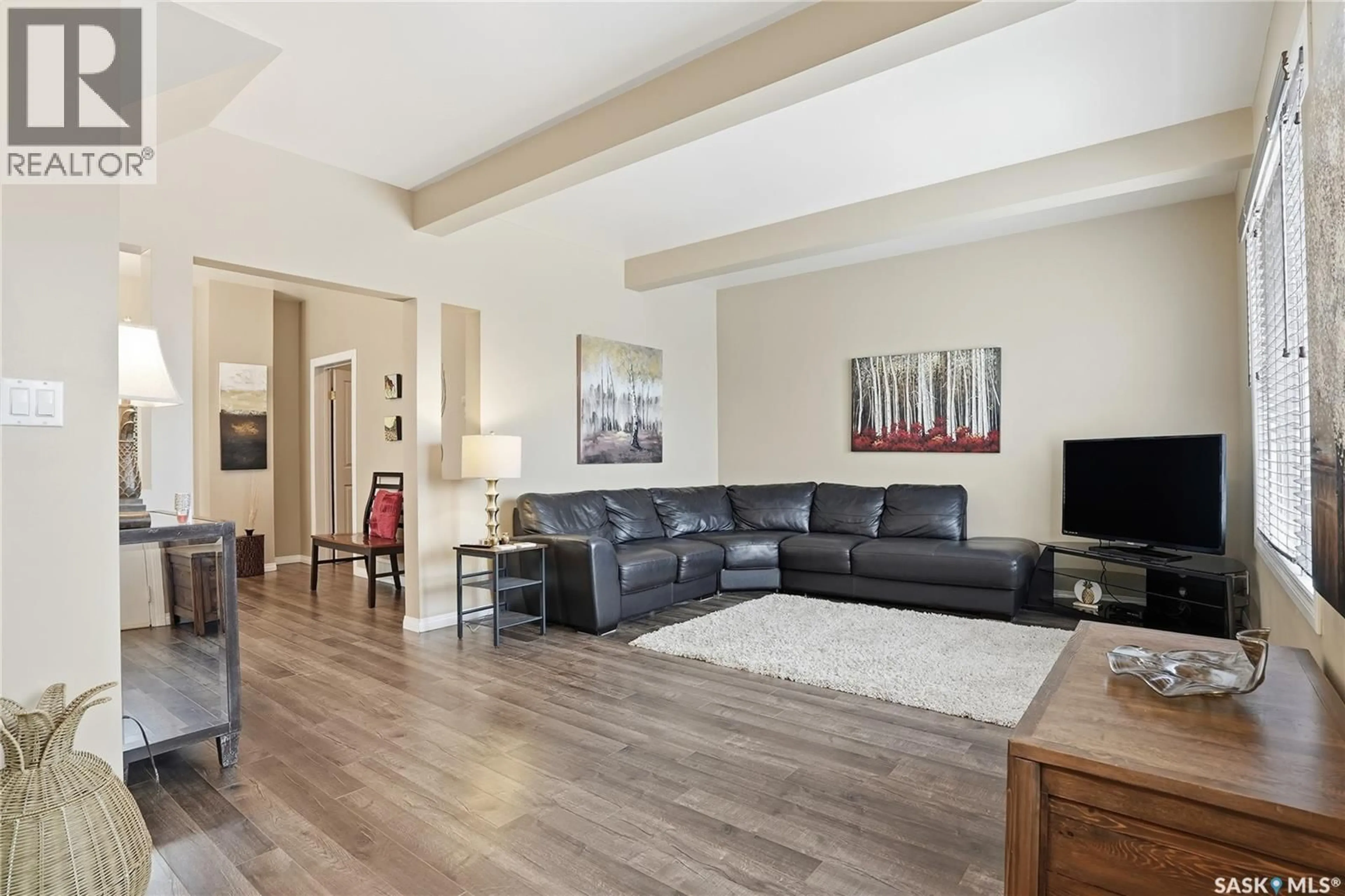 Living room with furniture, wood/laminate floor for 203 6TH AVENUE, Warman Saskatchewan S0K4S3