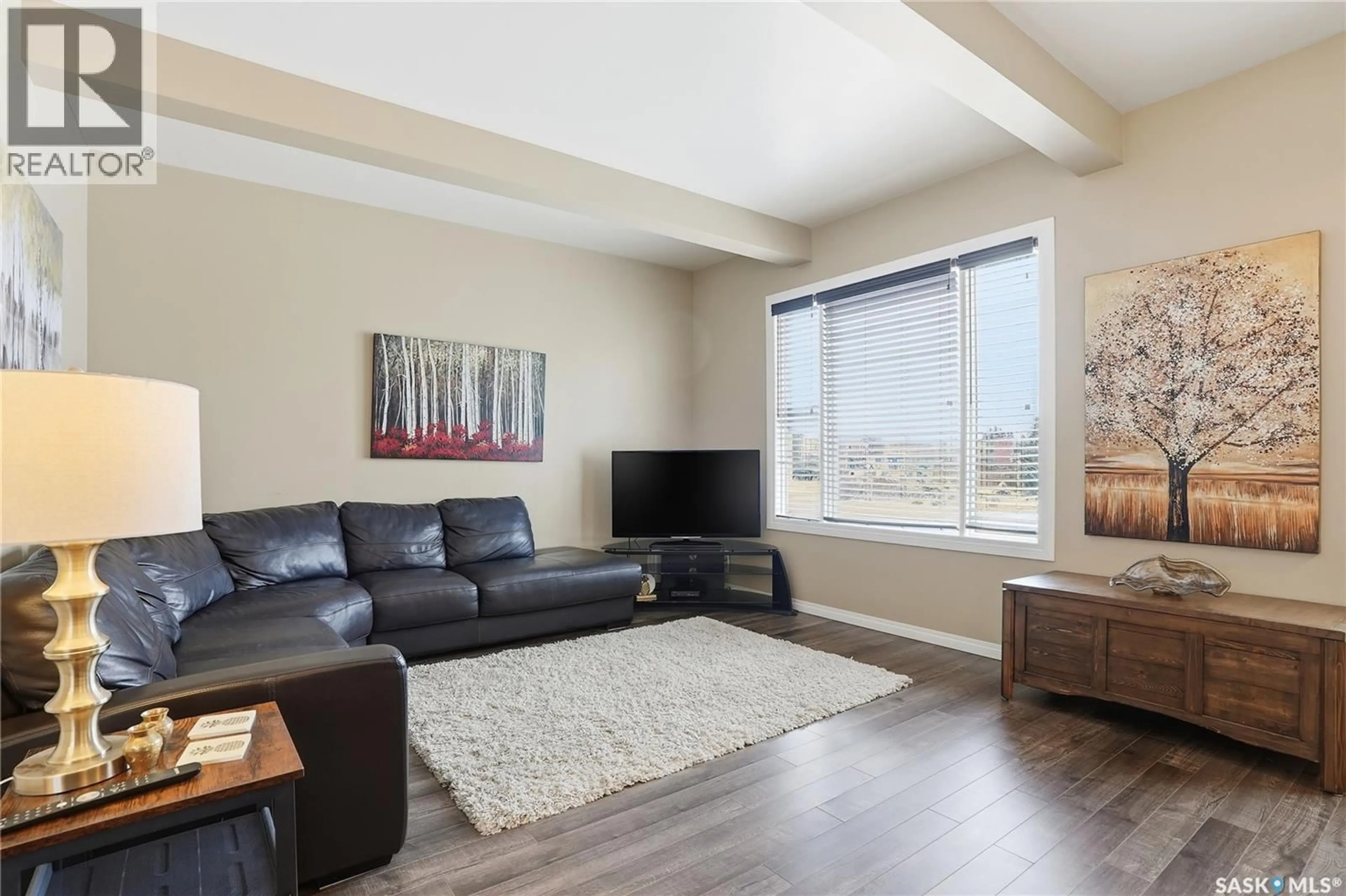 Living room with furniture, wood/laminate floor for 203 6TH AVENUE, Warman Saskatchewan S0K4S3