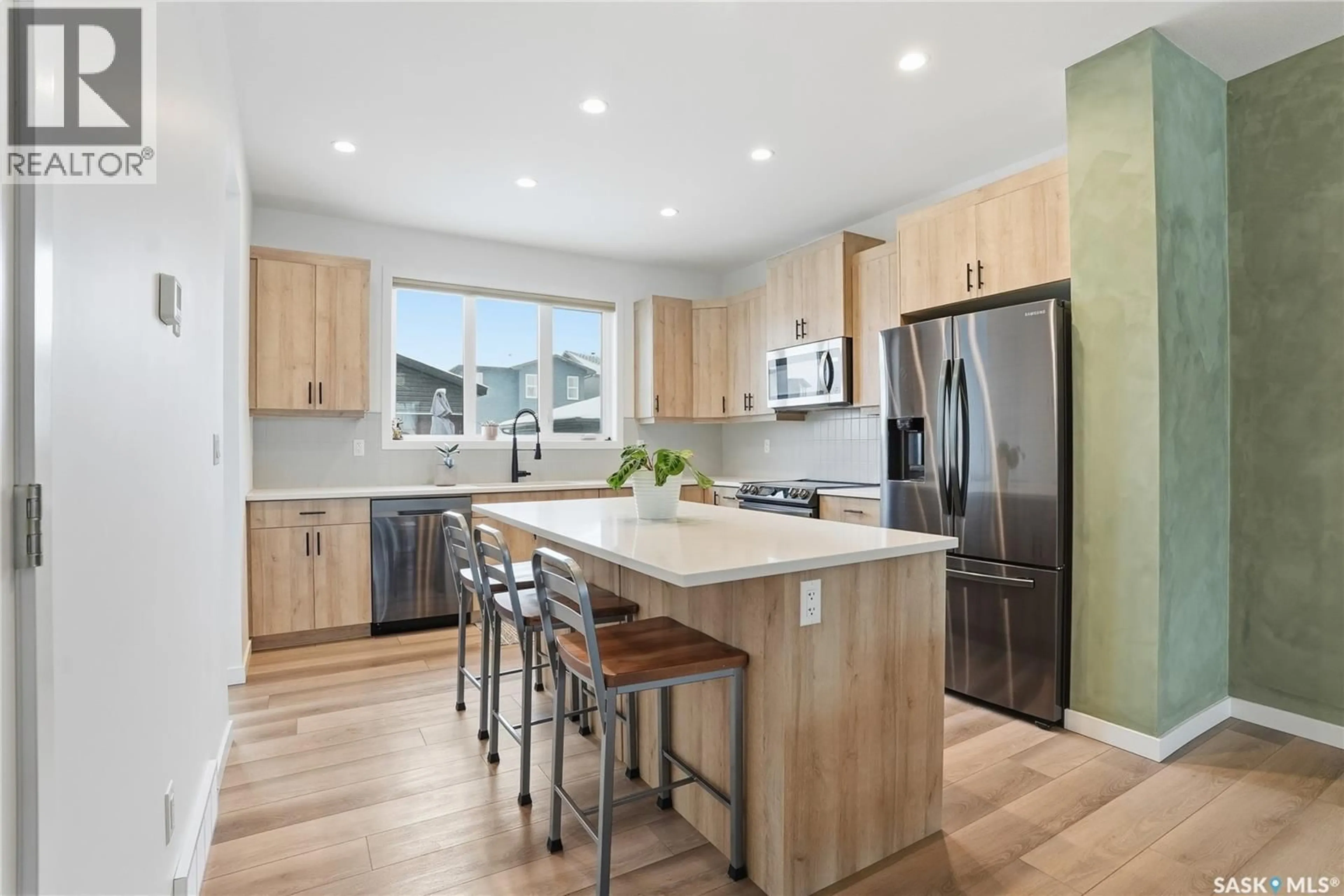 Open concept kitchen, wood/laminate floor for 147 TAUBE AVENUE, Saskatoon Saskatchewan S7V0W1