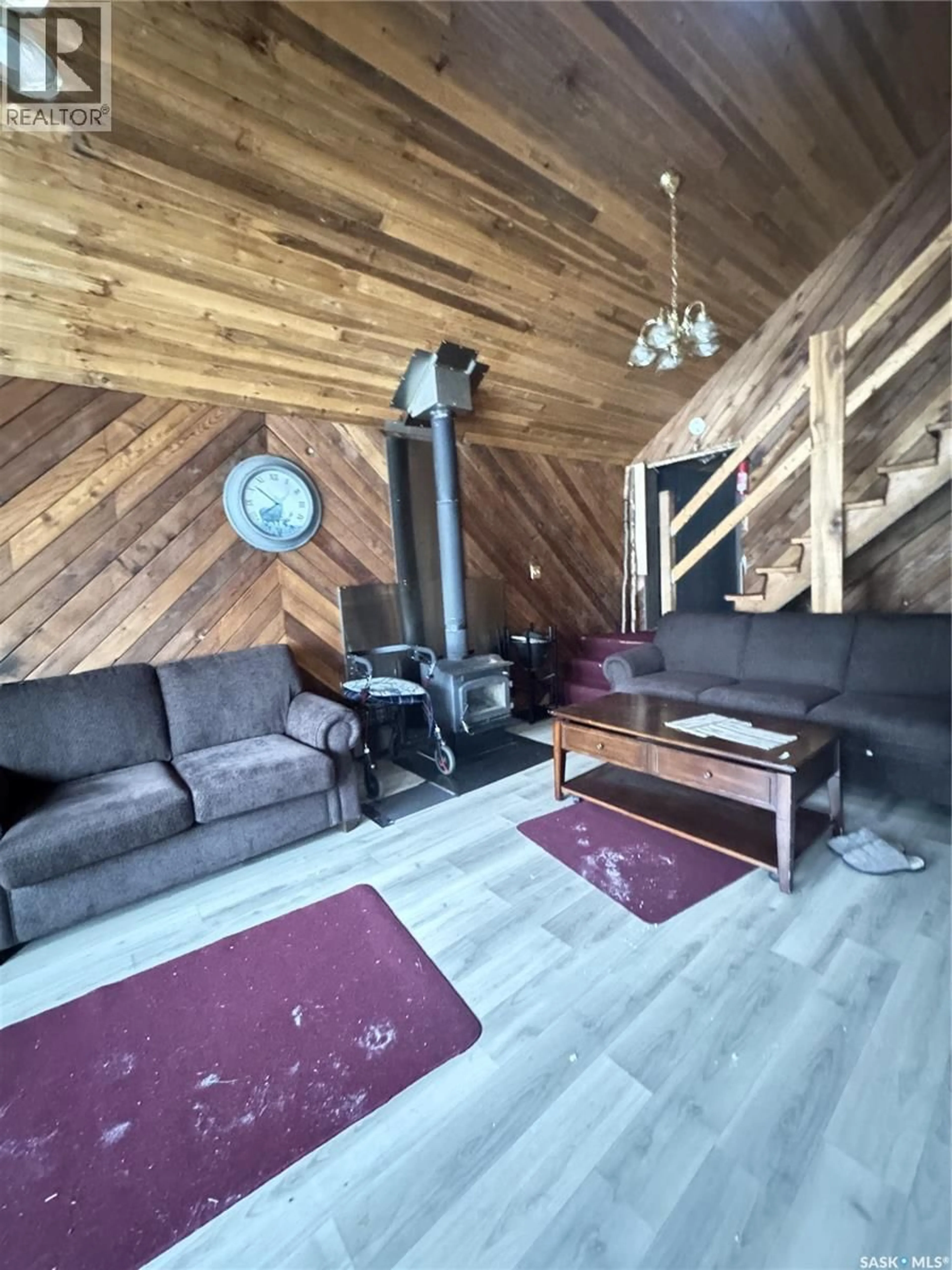 Living room with furniture, wood/laminate floor for 109 DEER CRES, Lakeland Rm No. 521 Saskatchewan S0J0N0