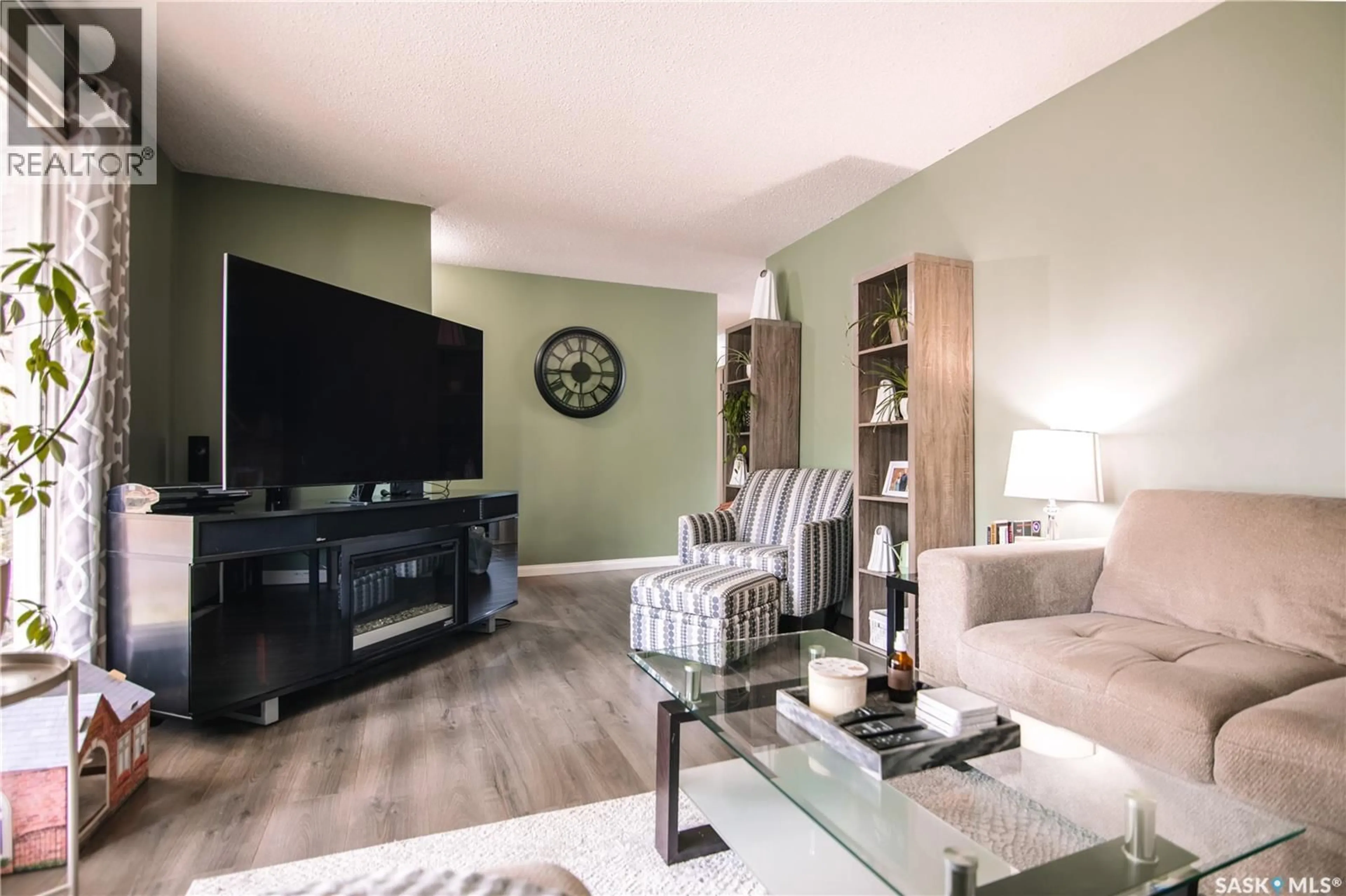 Living room with furniture, wood/laminate floor for 132 NAGEL CRESCENT, Regina Saskatchewan S4N1N9