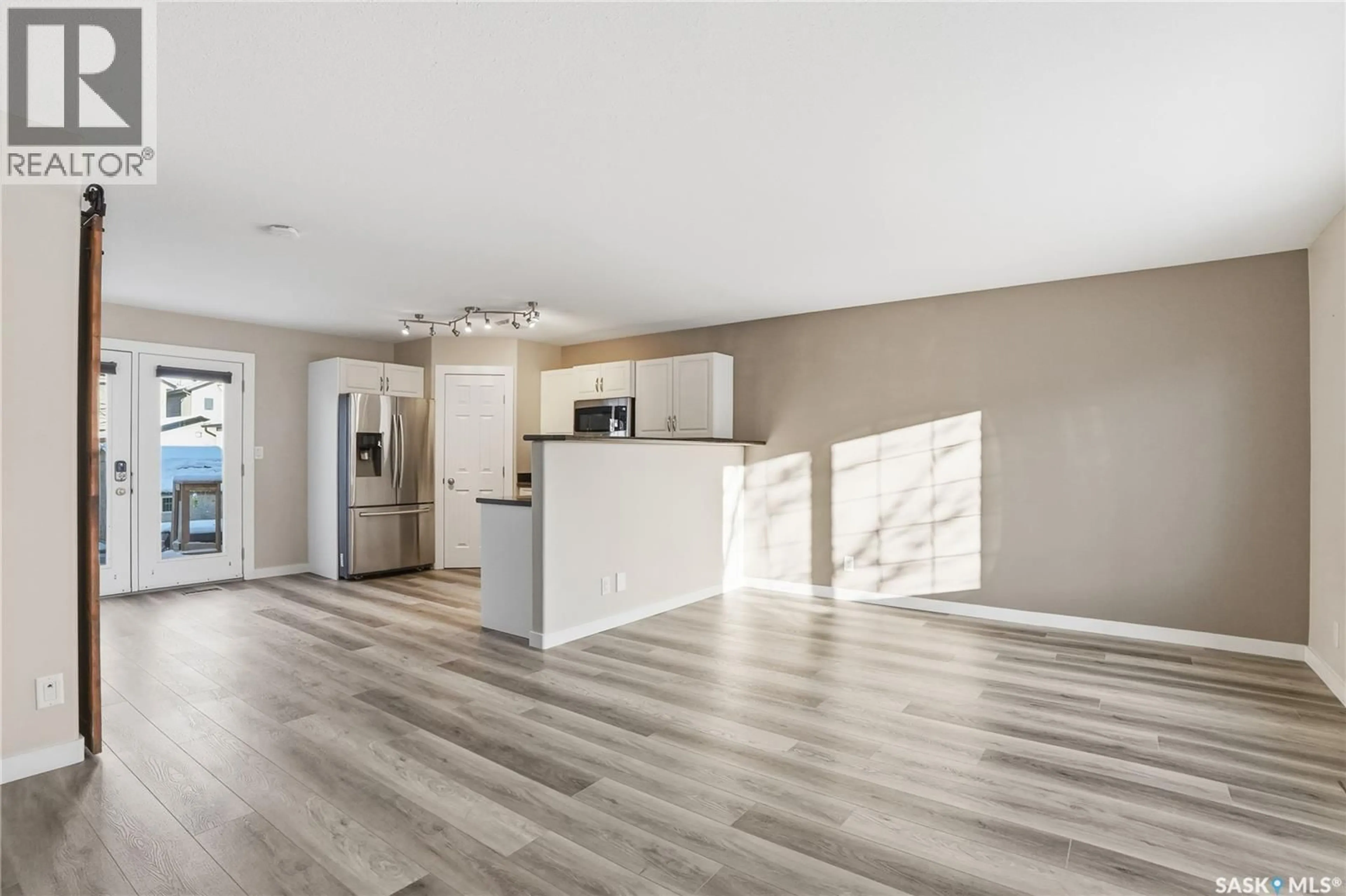Open concept kitchen, wood/laminate floor for 154 BLAKENEY CRESCENT, Saskatoon Saskatchewan S7L7N4