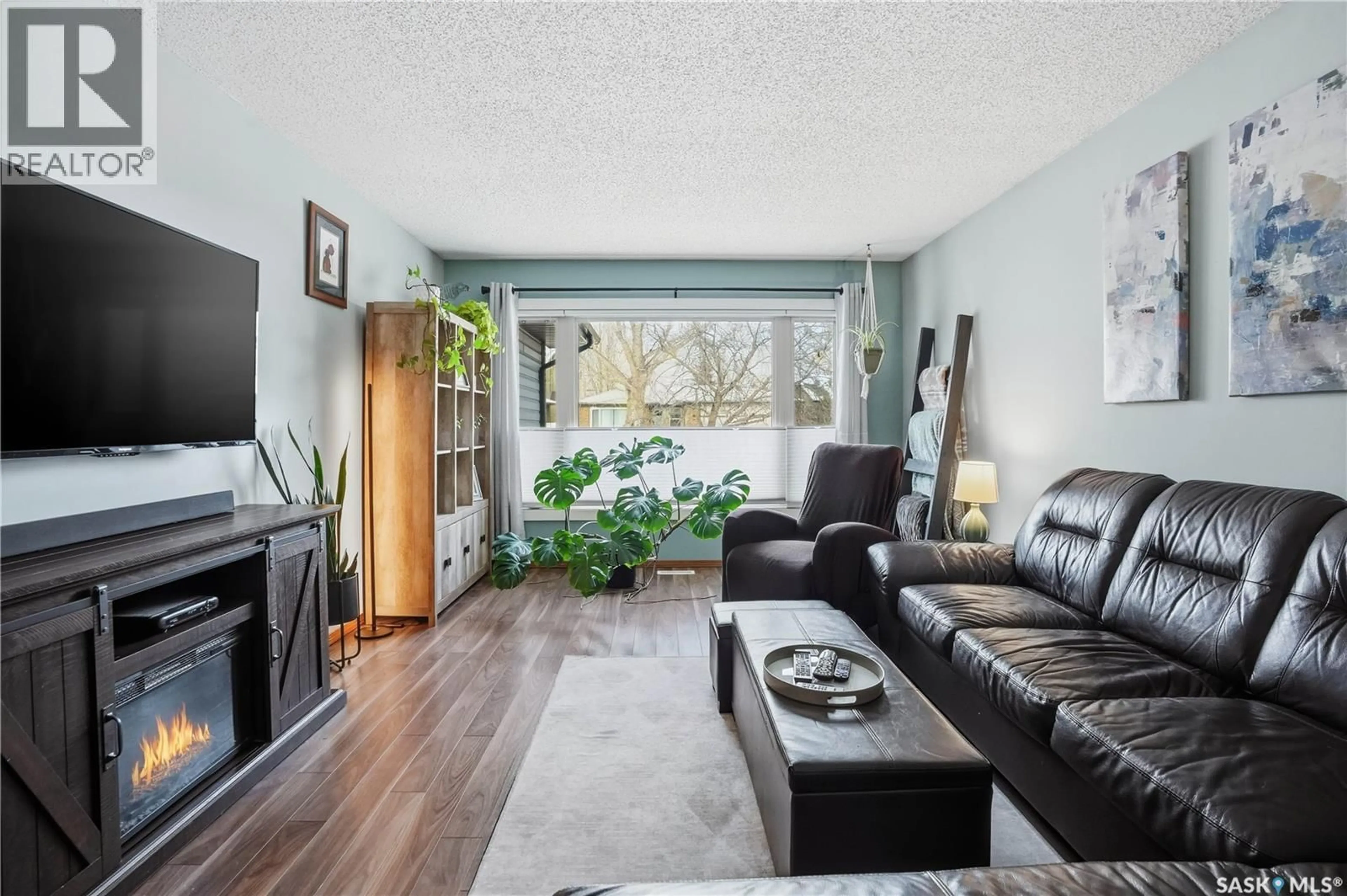 Living room with furniture, wood/laminate floor for 2815 CORBETT ROAD, Regina Saskatchewan S4R8J1