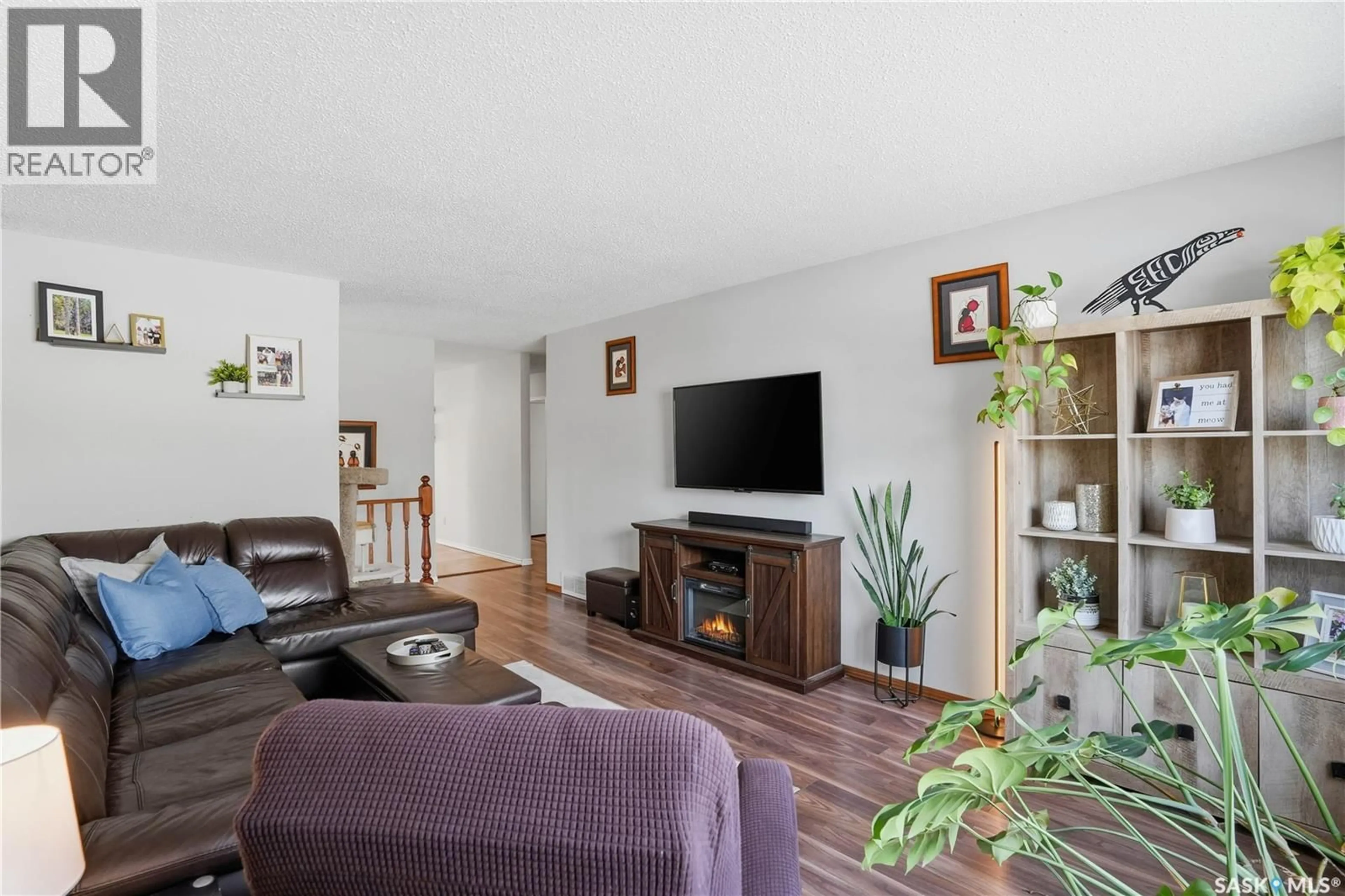 Living room with furniture, wood/laminate floor for 2815 CORBETT ROAD, Regina Saskatchewan S4R8J1