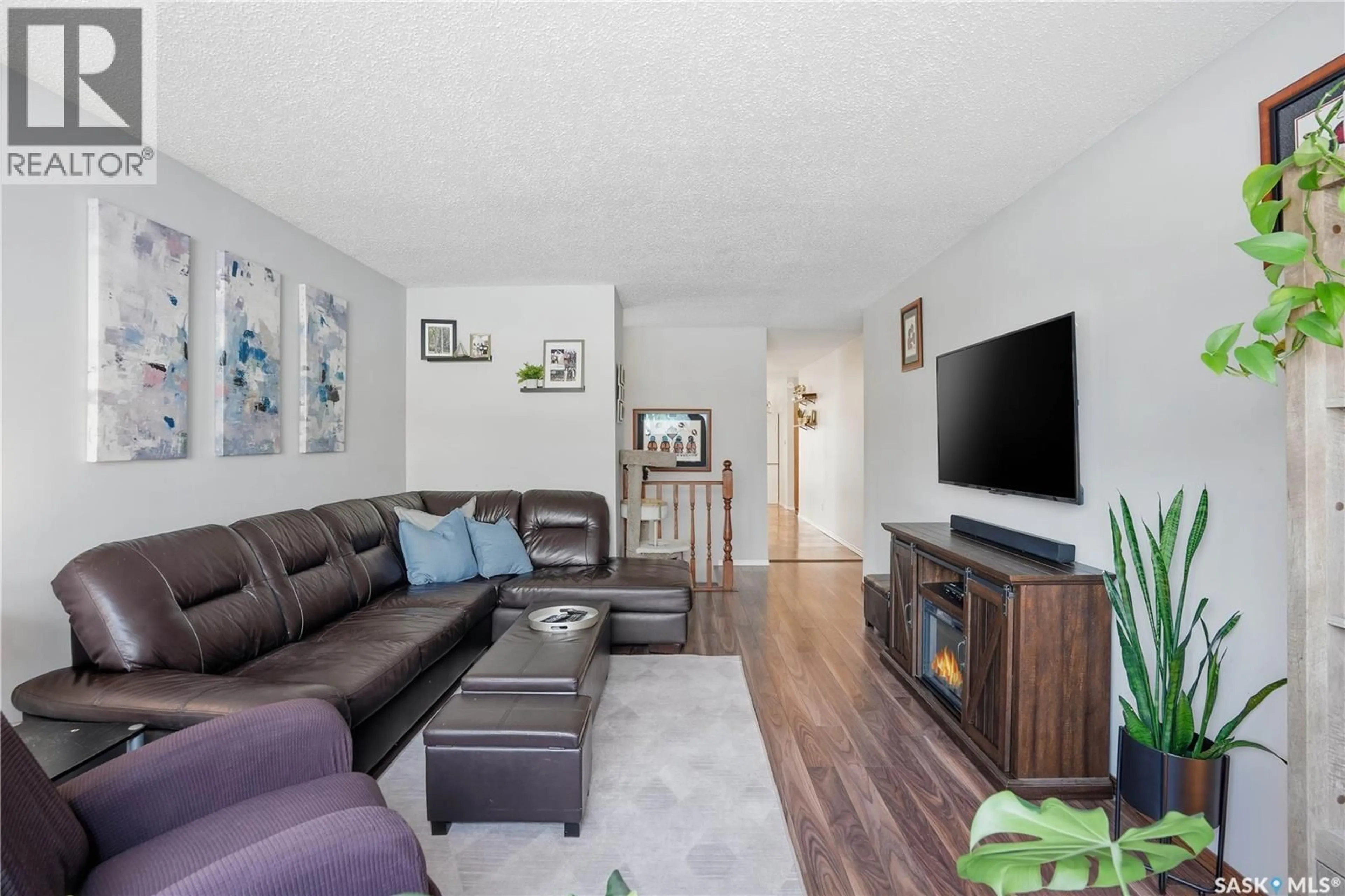 Living room with furniture, wood/laminate floor for 2815 CORBETT ROAD, Regina Saskatchewan S4R8J1