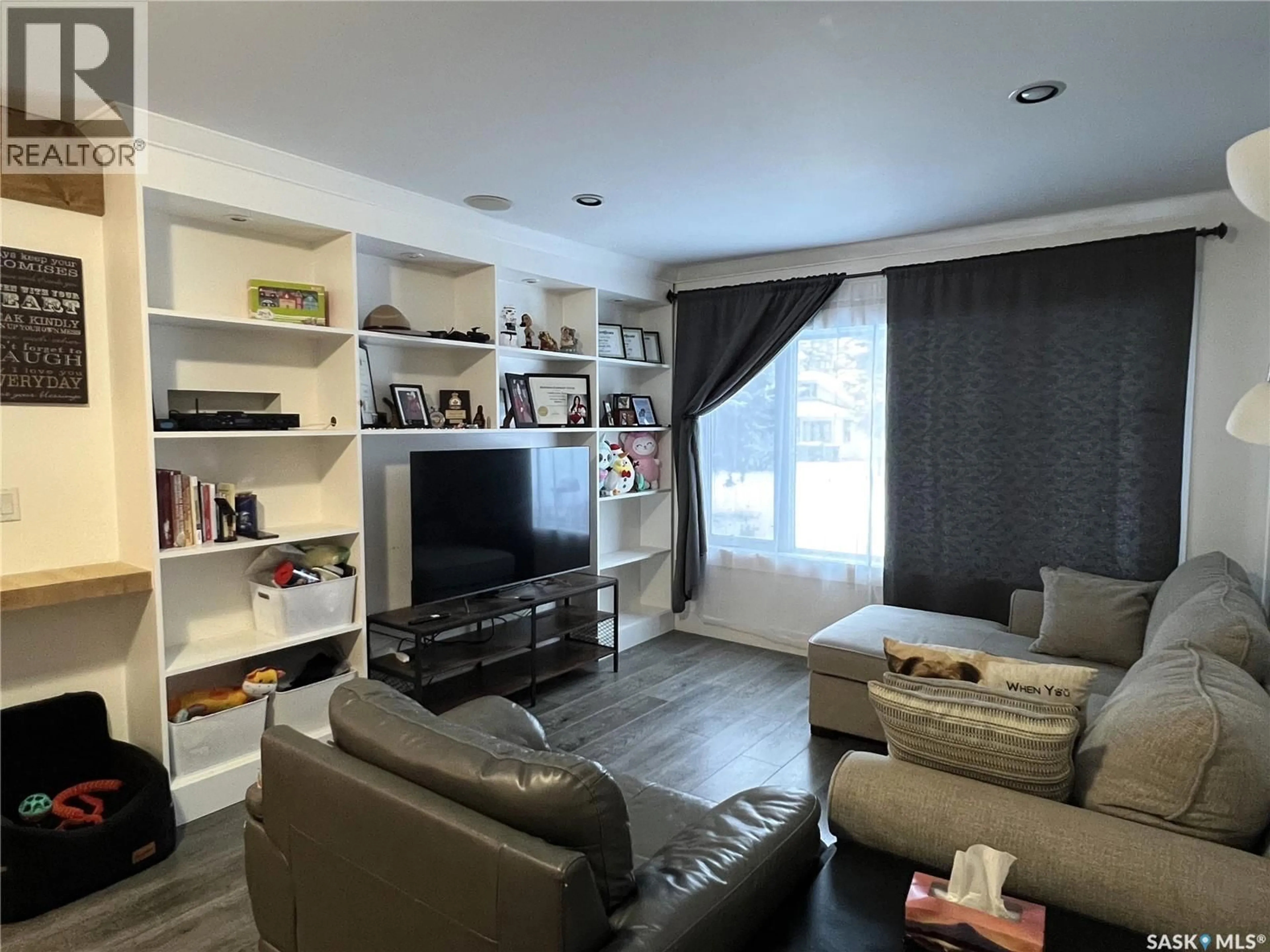 Living room with furniture, wood/laminate floor for 415 3RD STREET, Meadow Lake Saskatchewan S9X1C8