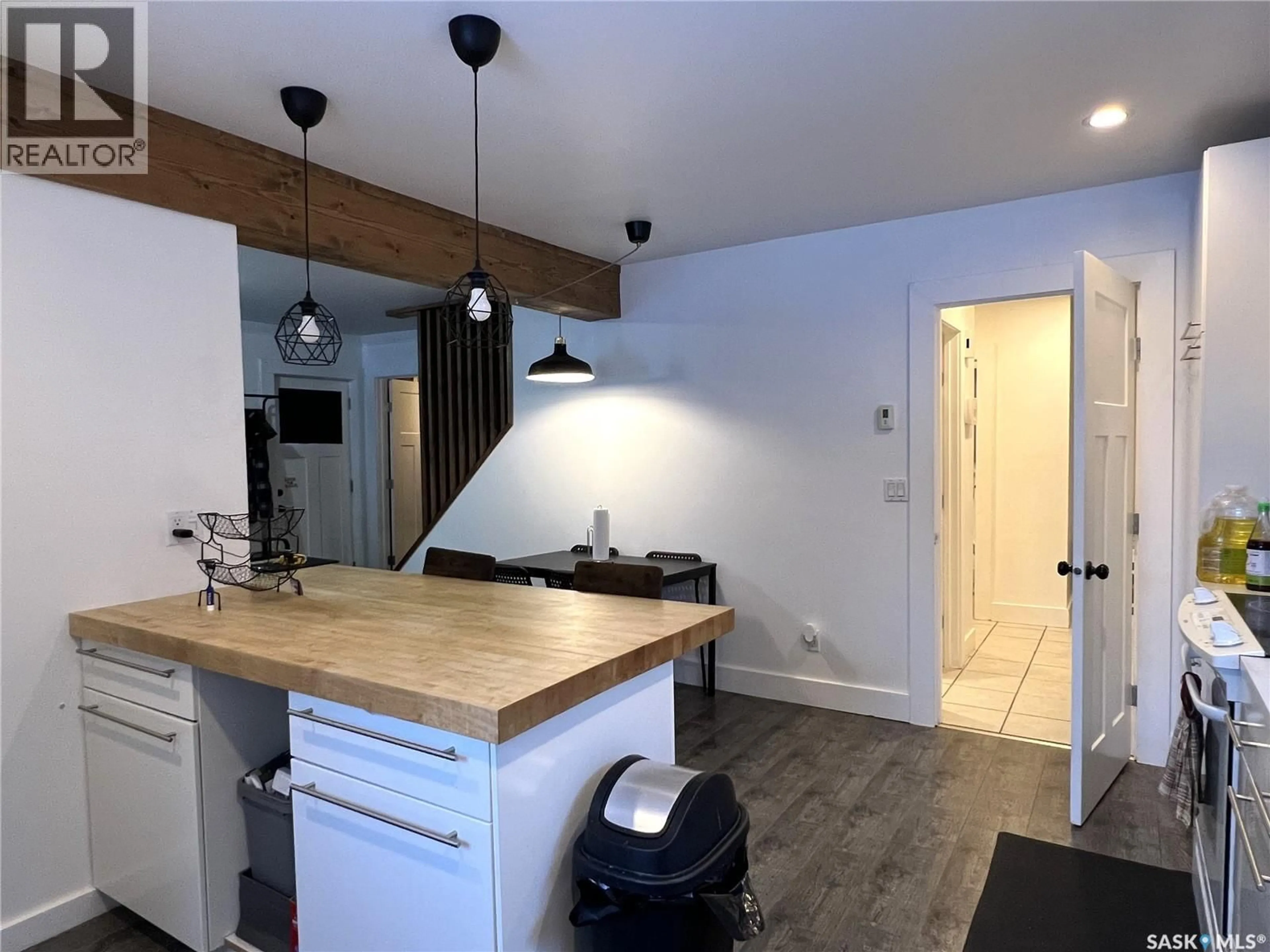 Open concept kitchen, wood/laminate floor for 415 3RD STREET, Meadow Lake Saskatchewan S9X1C8