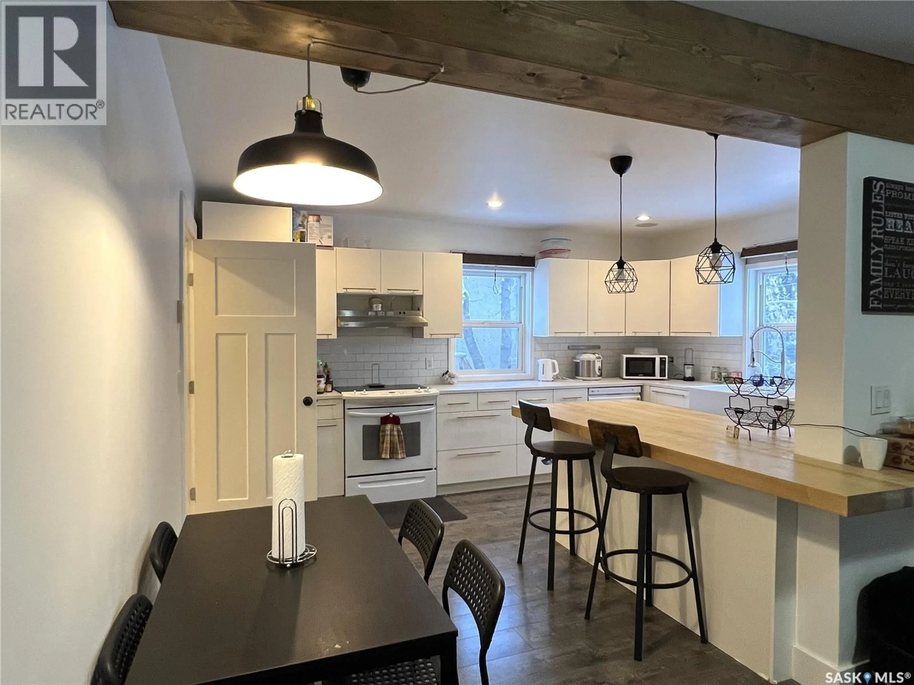 Open concept kitchen, wood/laminate floor for 415 3RD STREET, Meadow Lake Saskatchewan S9X1C8